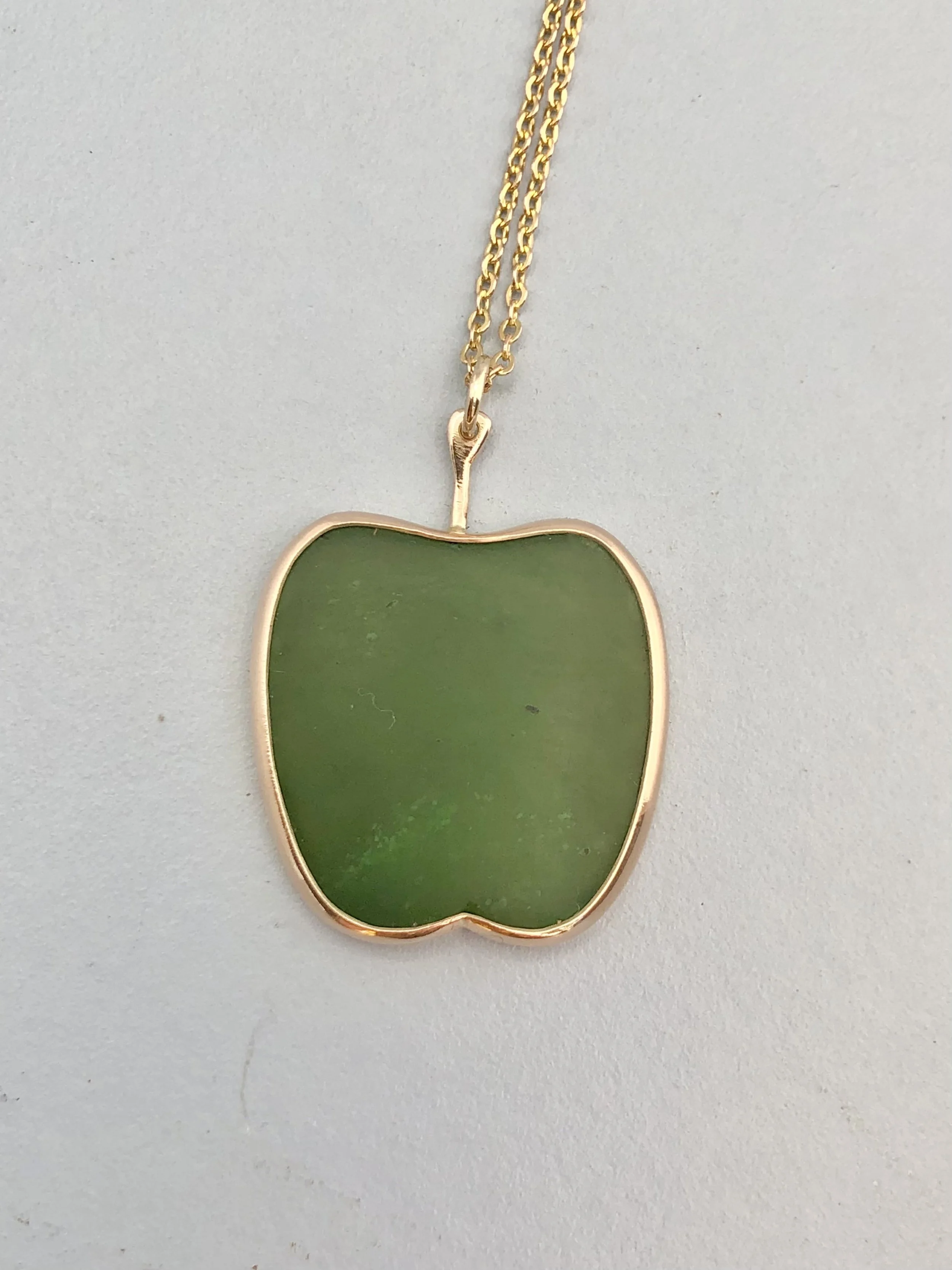 9k gold & NZ greenstone shown lying down from front view.