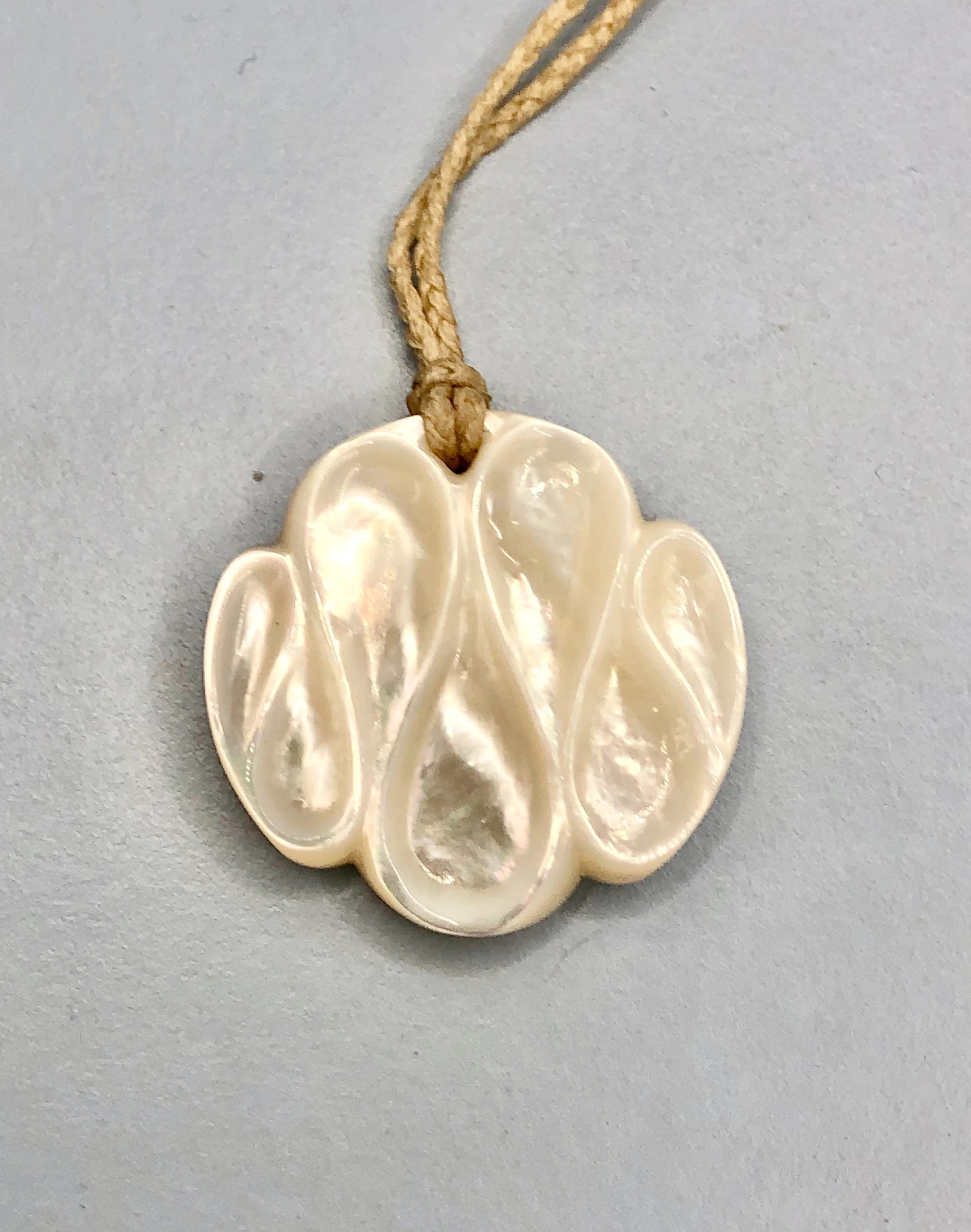 Front view of the carved mother of pearl pendant