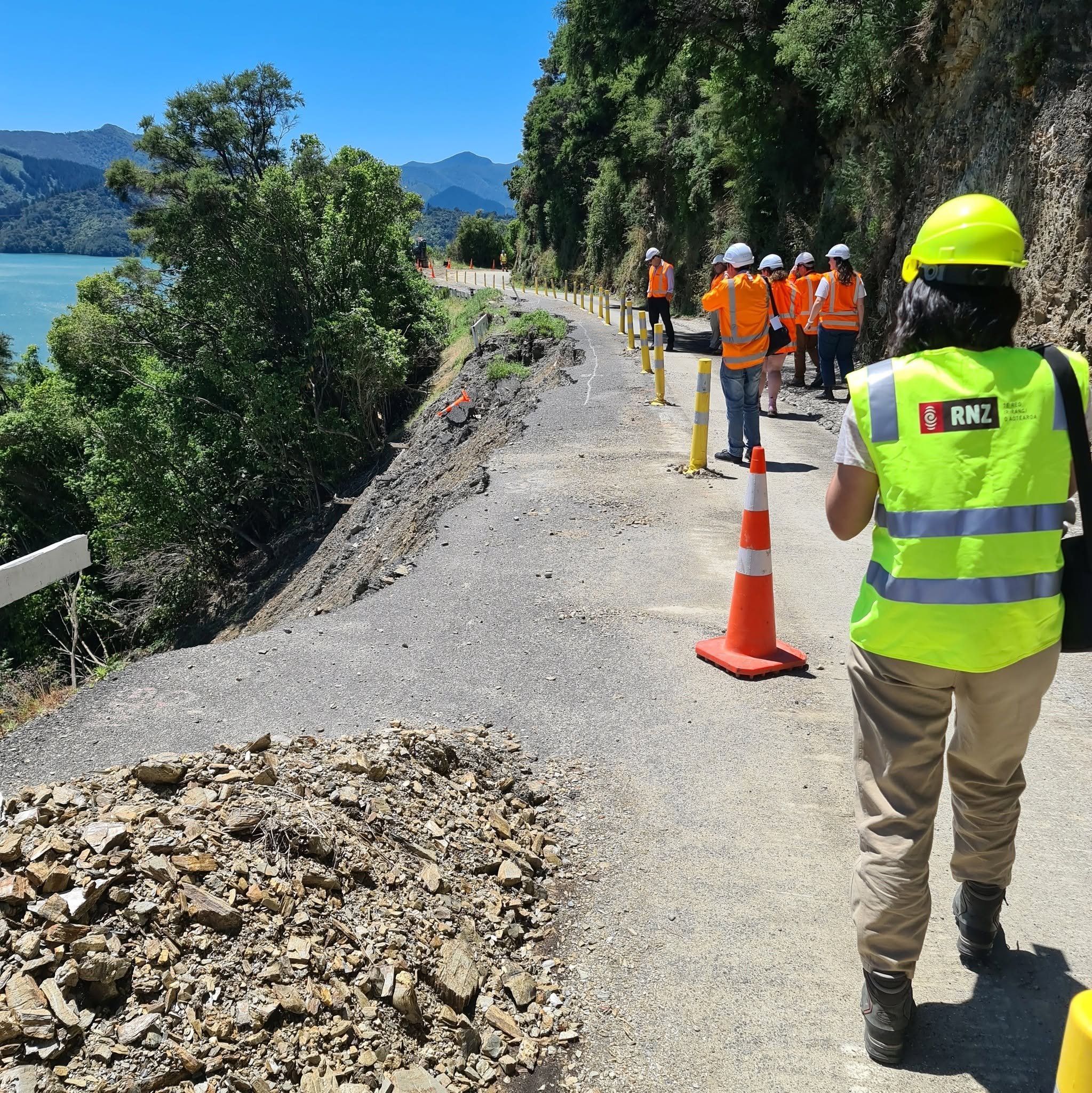 Media walk the storm damaged roads in the Sounds in 2021 to update the public about the access. 