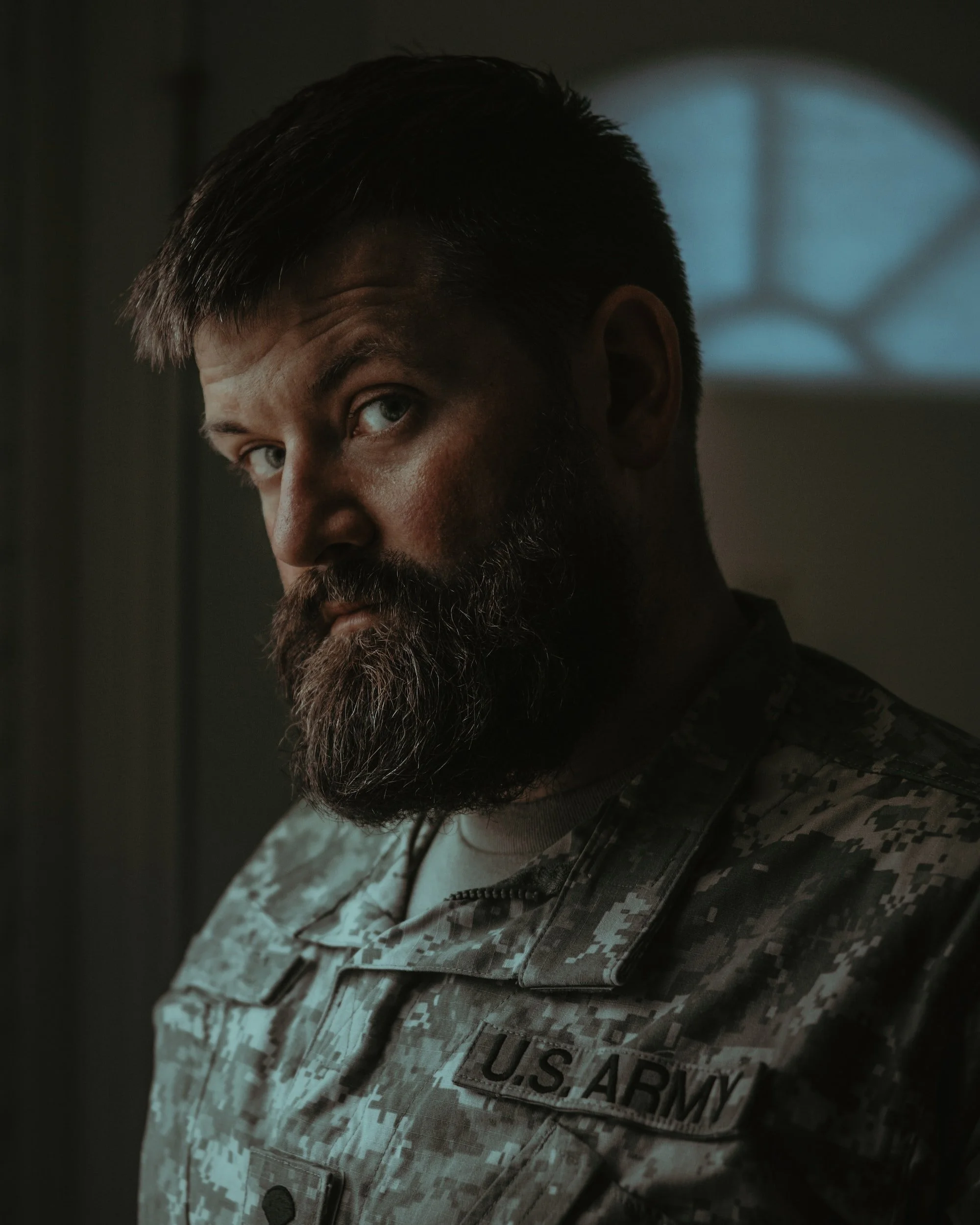 military man with beard looking anxiously at the camera,  cbt therapy, counseling for anxiety