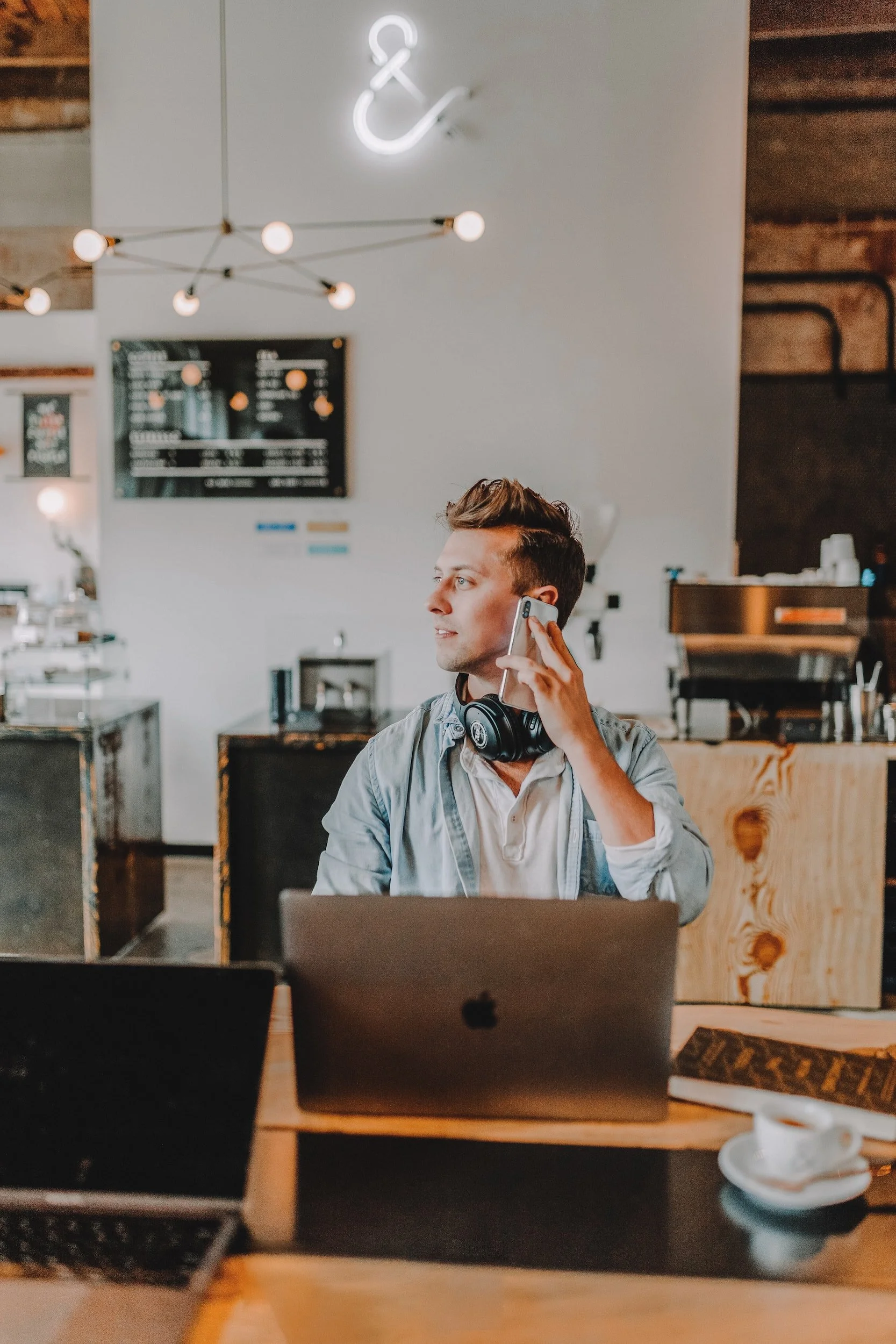 guy sitting at a coffee bar talking on the phone, life coaching, therapy services