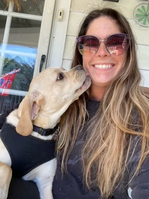 Five Paws pet sitter holding a relaxed dog in Broomall and surrounding areas.