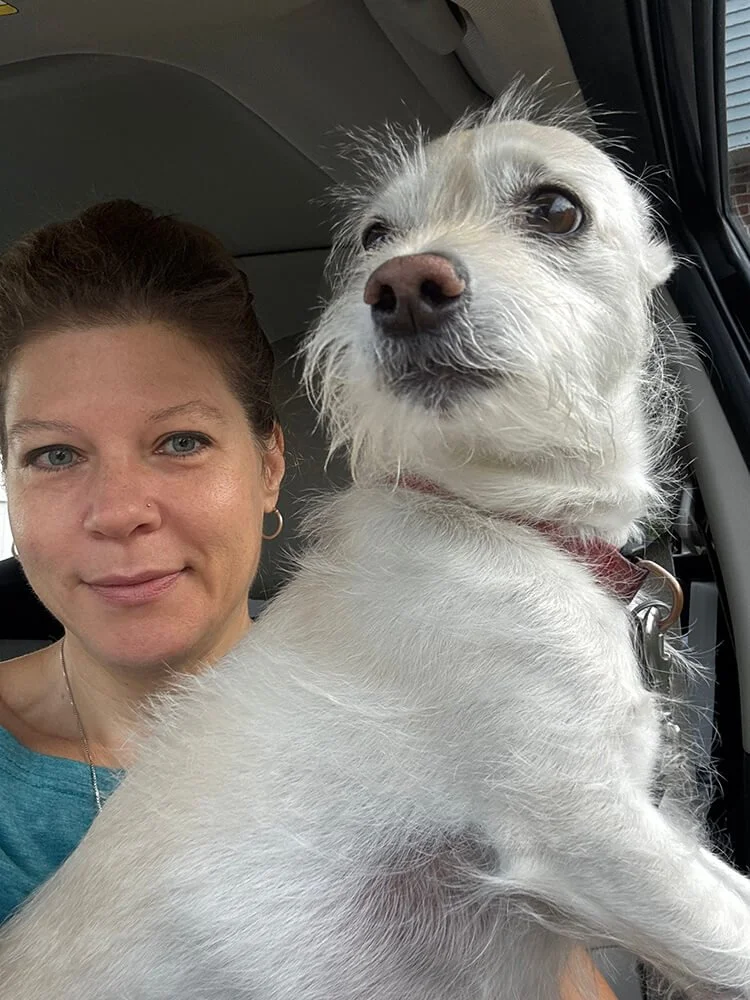 Kathleen, one of the Five Paws pet sitter based in Delaware County holding a friendly pet dog.