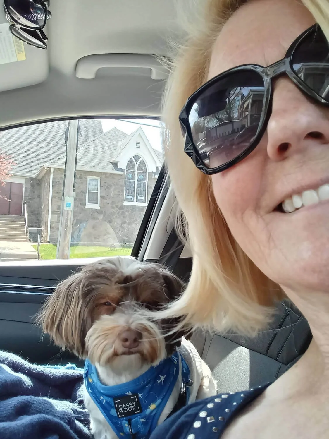 Melinda, one of the friendly senior dog sitter from Five Paws holding a small dog in Brookhaven