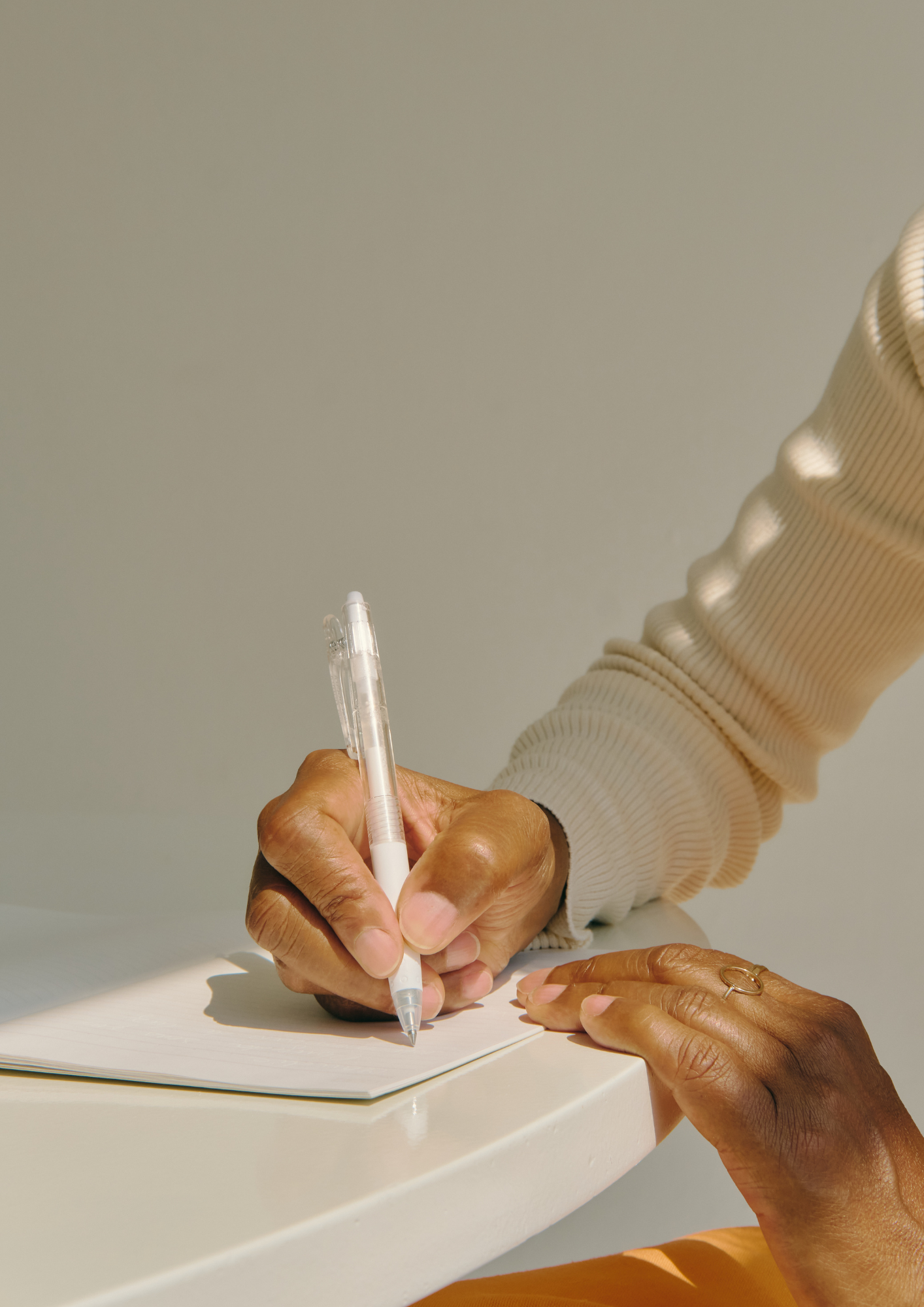 Person writing in a notebook, representing the Blood Test Cheat Sheet for interpreting results using functional reference ranges.
