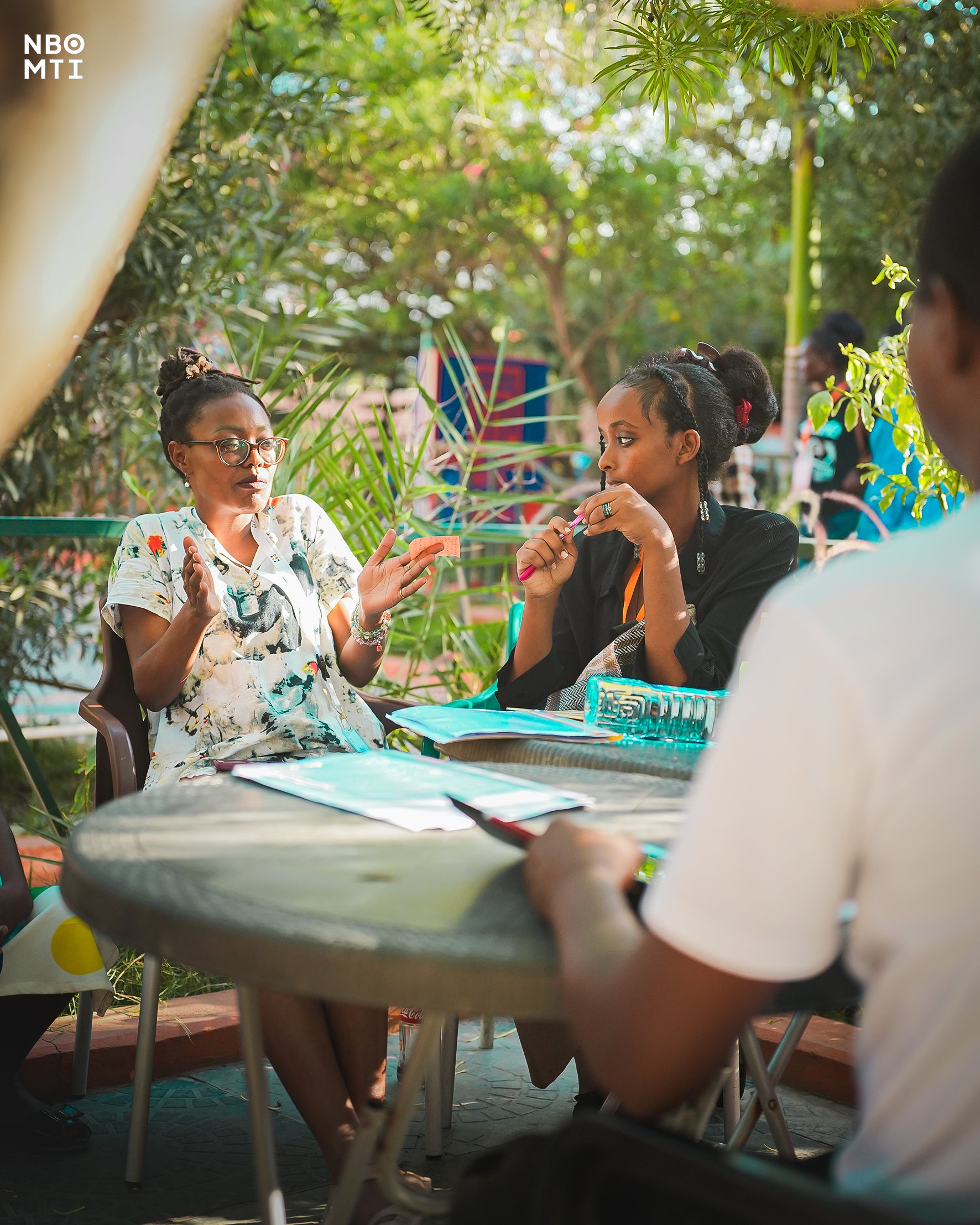 Ankhadada explaining a point in a group setting at NBO MTI Producing Workshop in Mombasa.