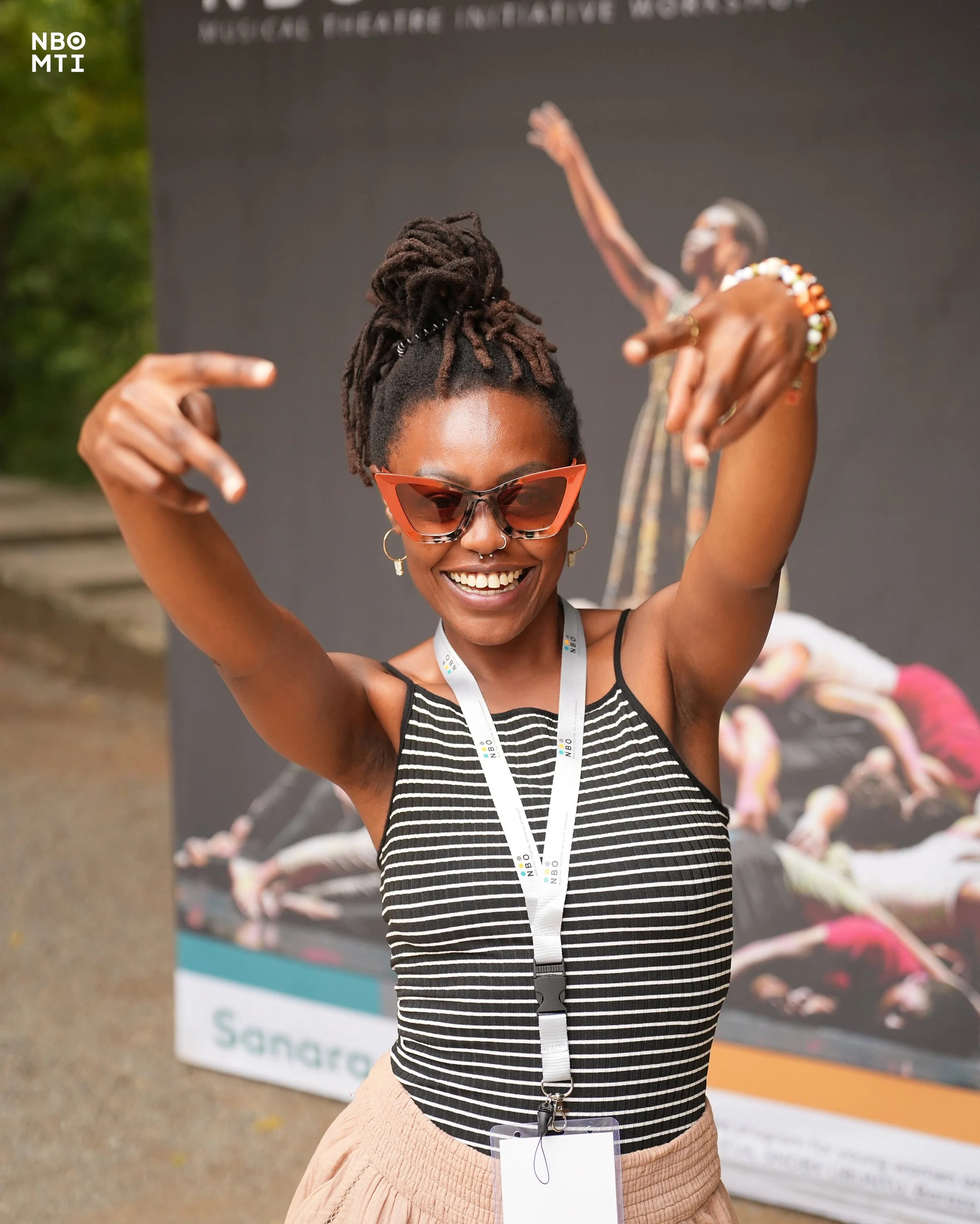 Ankhadada's with two hands up posing for a picture at NBO MTI Producing Workshop in Mombasa