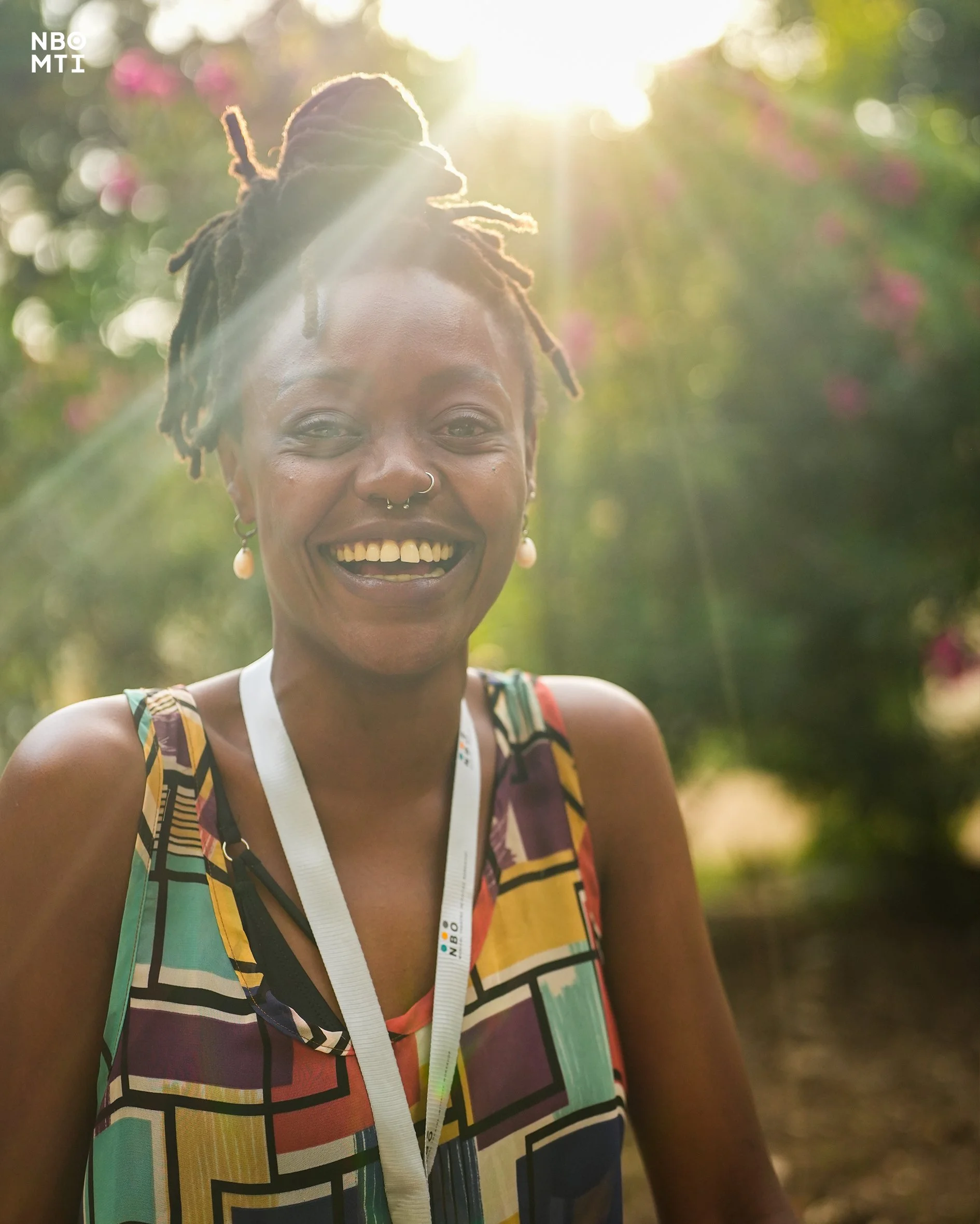 Ankhadada's profile picture with a ray of sunshine shining above her left side of the head illuminating her eyes at NBO MTI Producing Workshop in Mombasa.