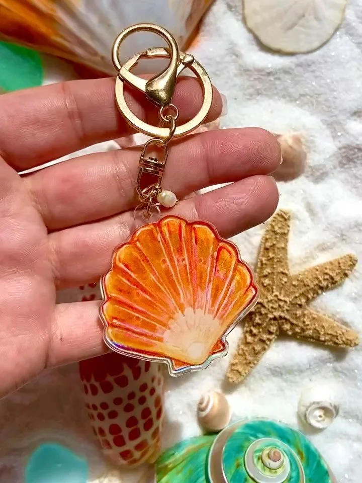 Scallop Shell Purse Charm ✨🩵🧜🏼&zwj;♀️

The scallop shell represents protection and safe travels, a perfect symbol for life's adventures ⛵️🌏🐠

#pursecharm #pursecharms #seashellcharms