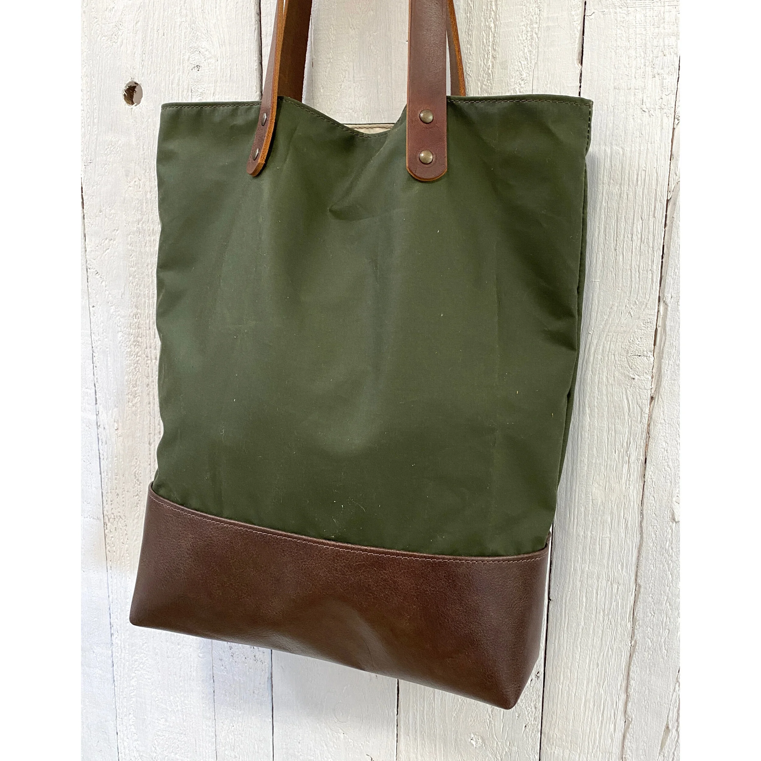 Green and brown leather tote bag
