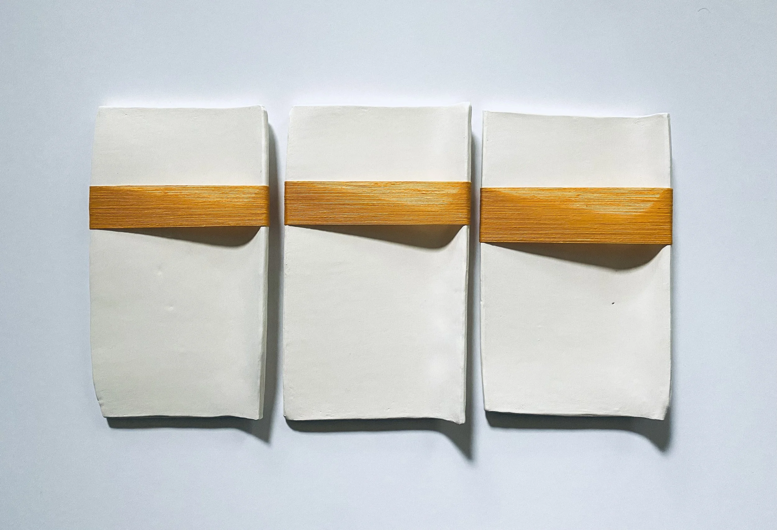 Ariel Bullion Ecklund, The Lightness, 9" x 18" x 1", stoneware, paint, wax and waxed thread, 2024