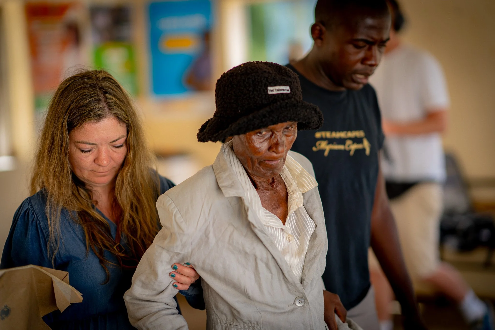 Ynghild helping elderly woman at health clinic