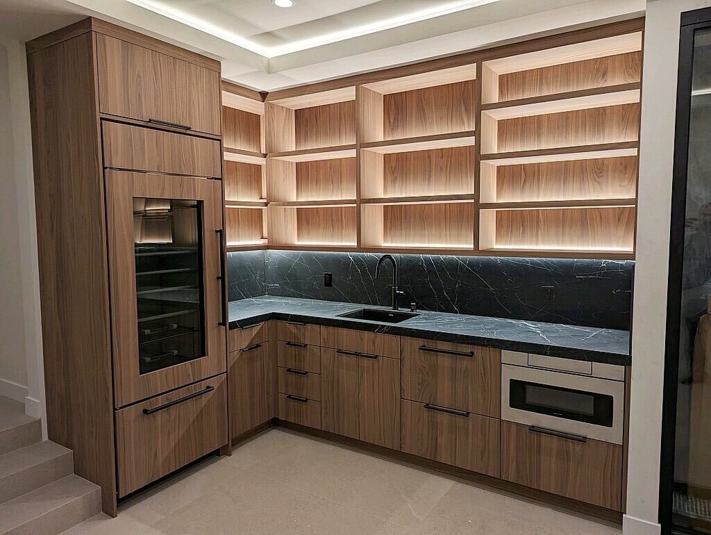 Entertainment in style with this classy custom wet bar. This client was looking for a show piece and we delivered! Ready for happy hour! #fancy #wetbar #interiors #classy #walnut #porcelain #black #countertops #pacificrestoration #encinitas #cali