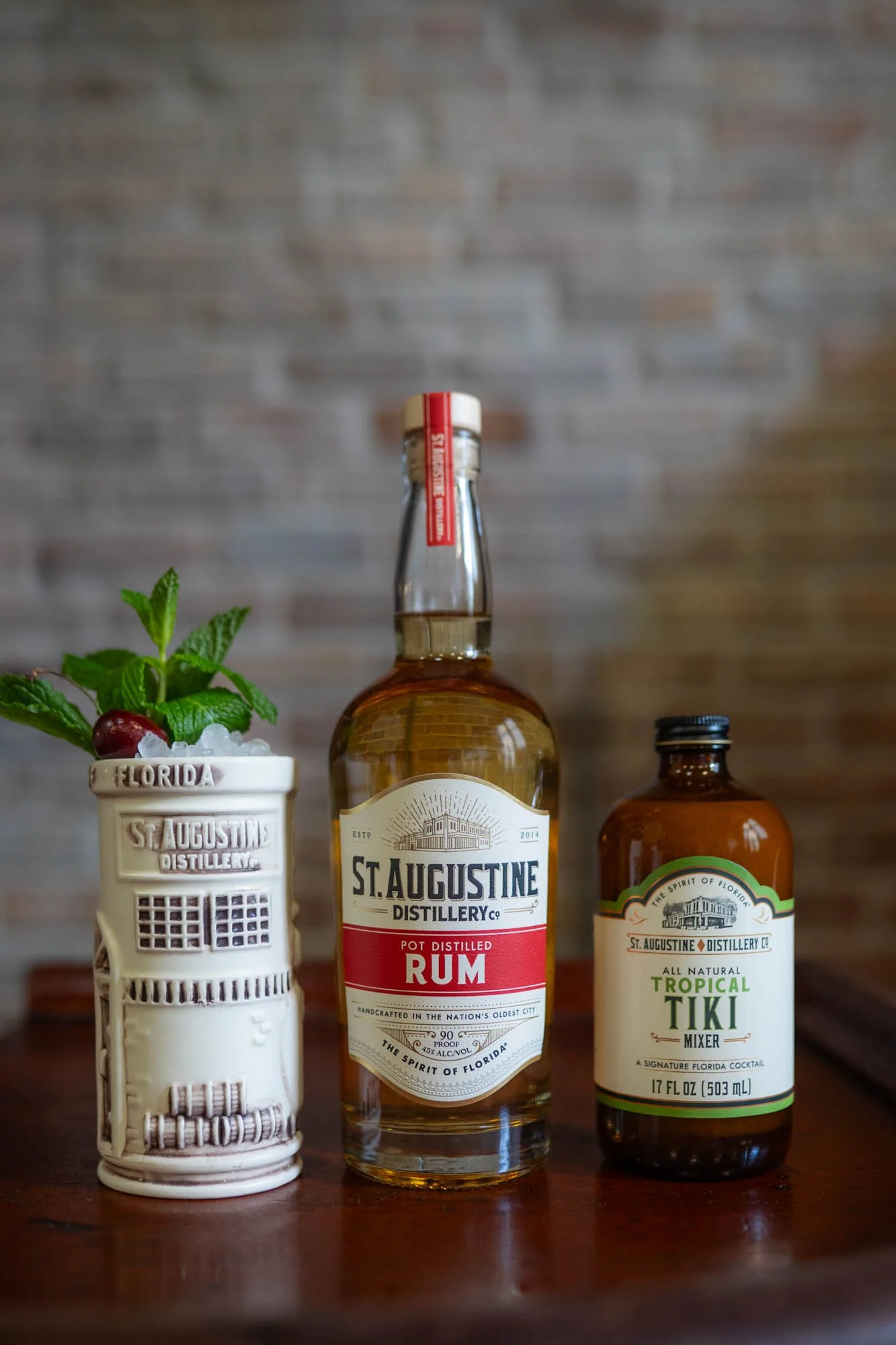 Tropical Tiki Mix with cocktail in tiki mug and bottle of Pot Distilled Rum