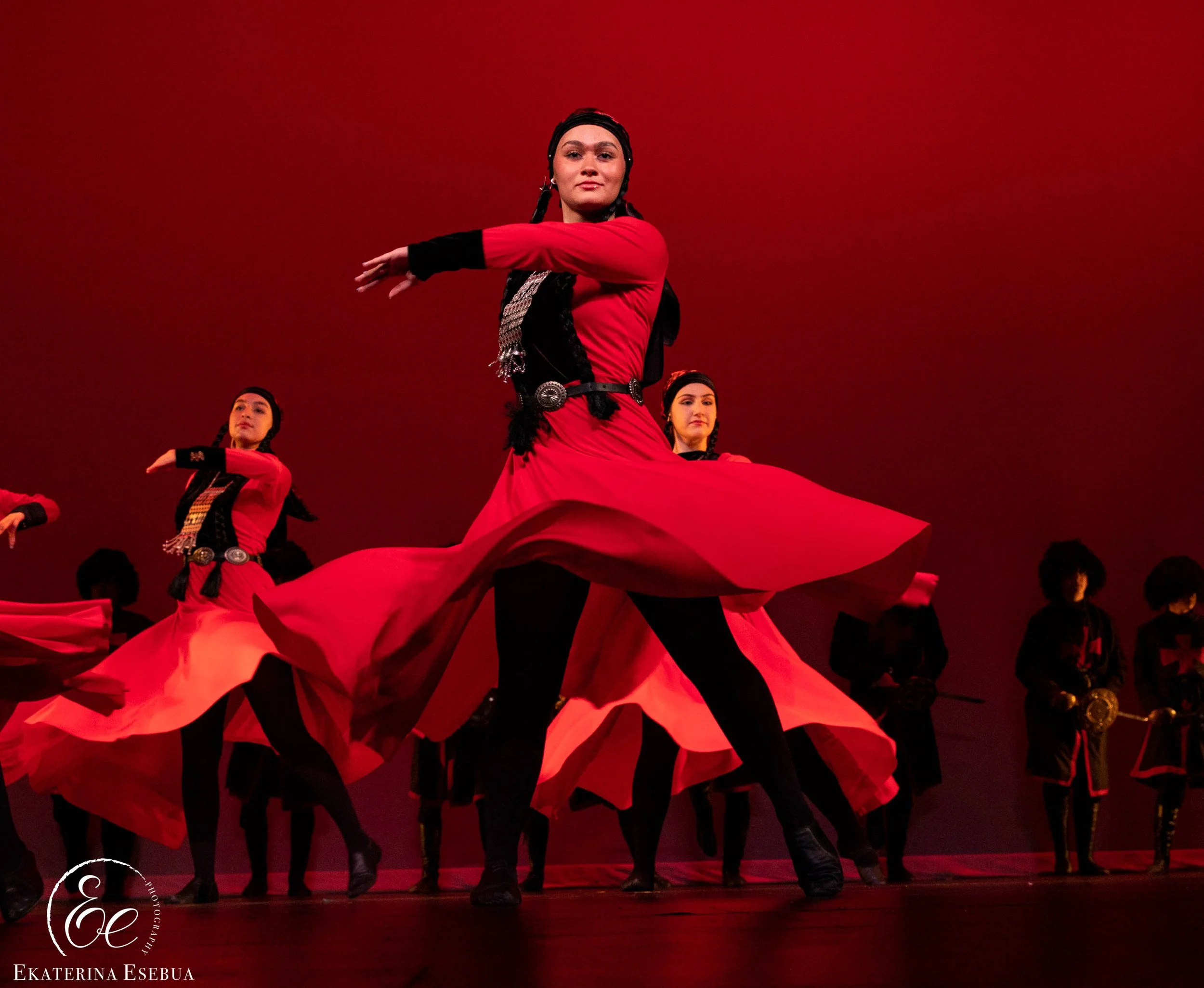 Vibrant traditional dance troupe and dramatic stage lighting photography by Ekaterina Esebua