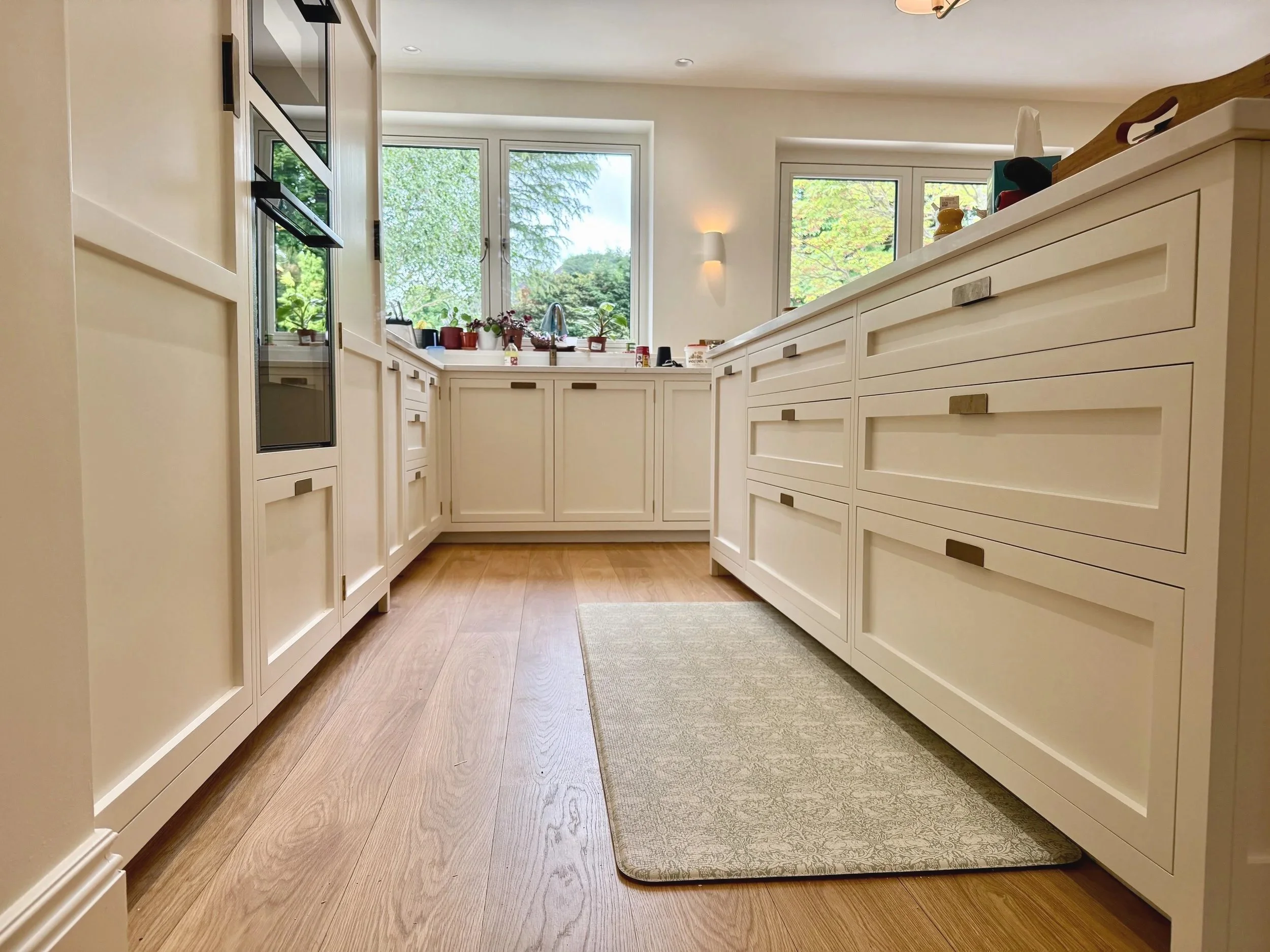 A stunning kitchen by Higham Furniture hand painted by Larsen Paint Finishes in Little Greene 'Silent White'  in Sutton, London