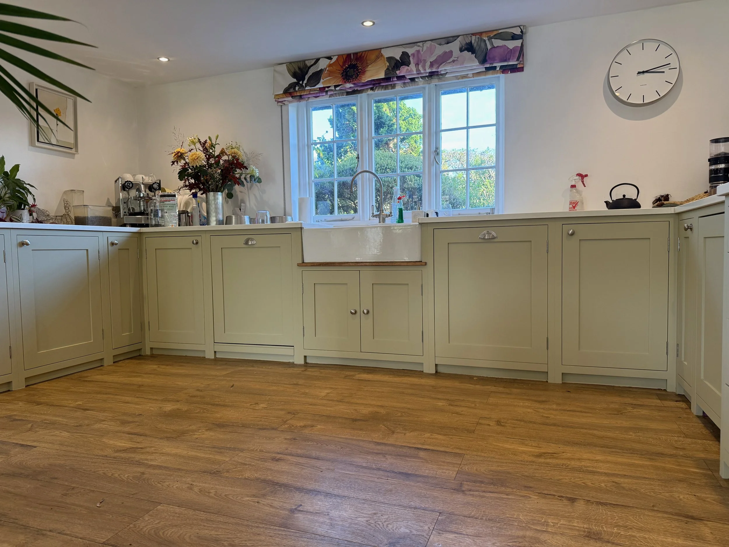 A refurbished kitchen, originally in wood hand painted in Farrow & Ball 'French Gray' in Tikkurila Helmi 10 equivalent and new handles by Hafele
