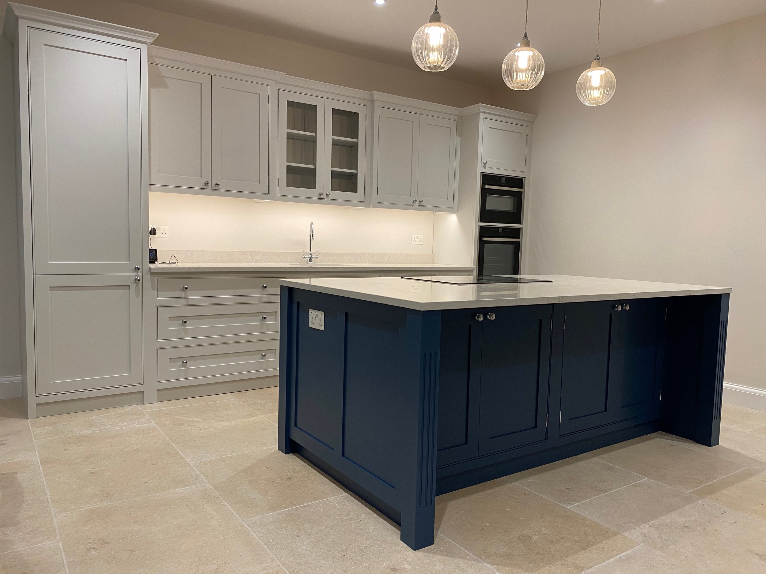 A Handmade Kitchen of Christchurch hand painted in Farrow & Ball 'Cornforth White' and 'Hague Blue' for the island, colour matched by Tikkurila in Helmi 10 finish, Sutton