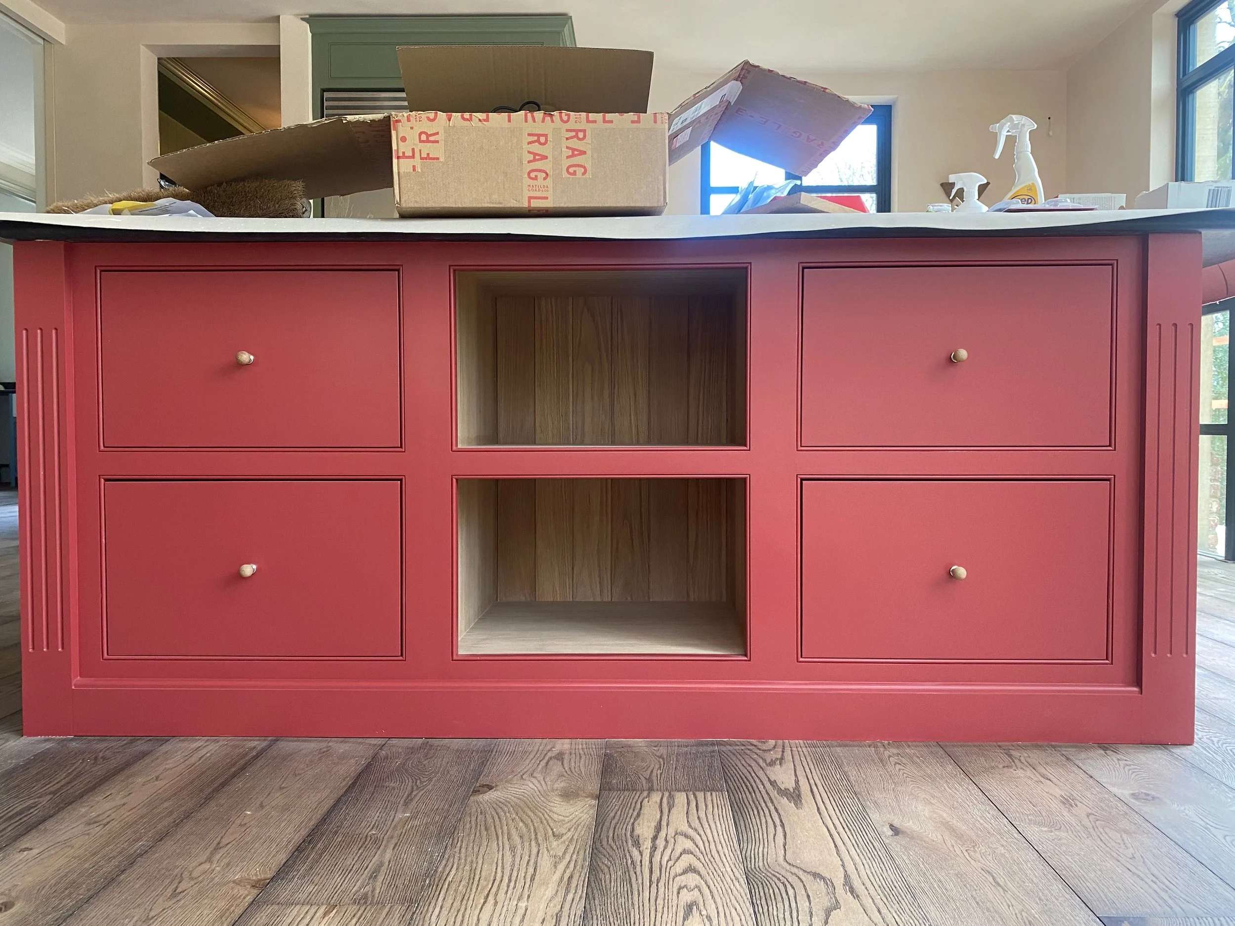 An island by Handmade Kitchens of Christchurch in Haslemere hand painted in Farrow & Ball ' Picture Gallery Red' equivalent in Tikkurila Intact 8