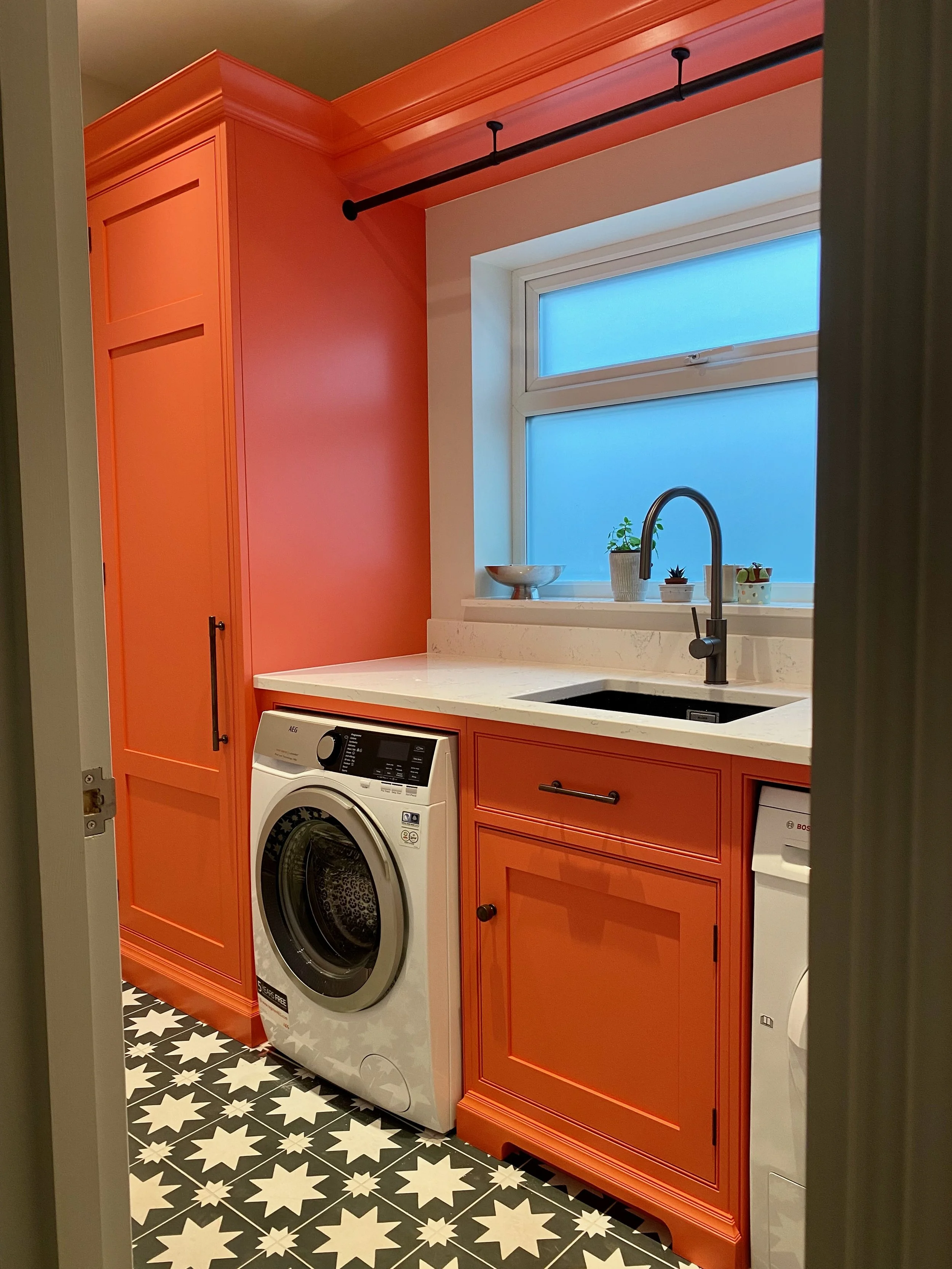 A stunning utility room by Cutler & Berry hand painted in a punchy colour!