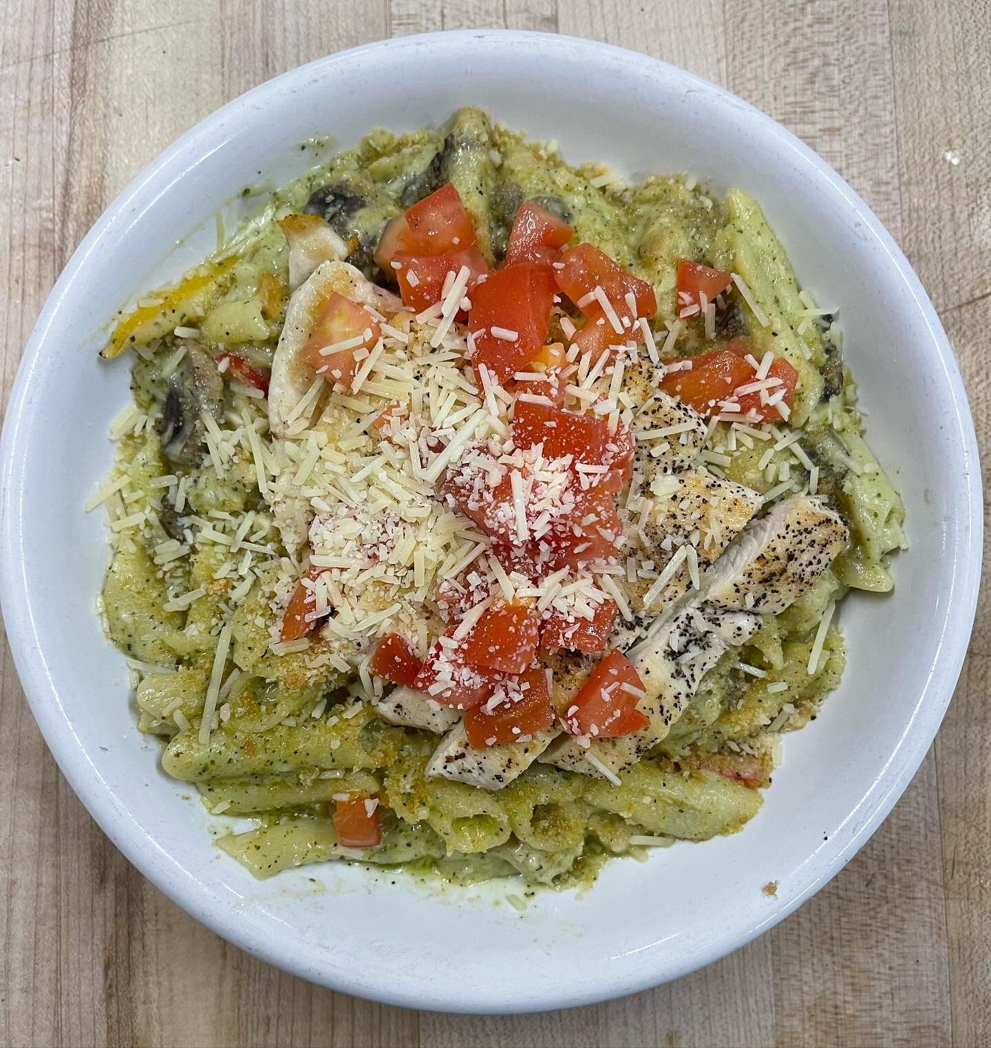 Todays lunch special is pesto penne pasta with grilled chicken, mushrooms, peppers, tomatoes, and Parmesan cheese.