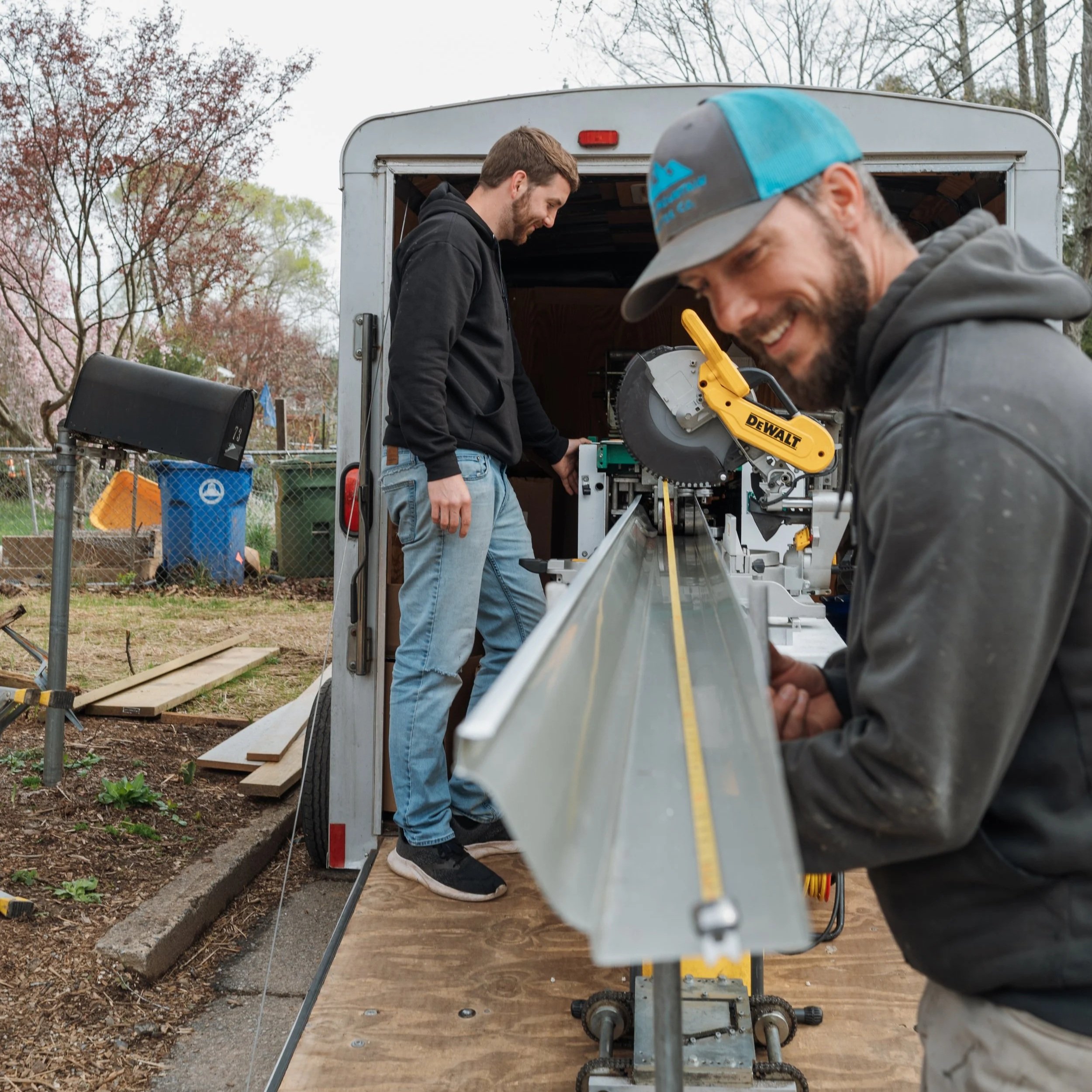 Our crew of gutter installers prepping the gutters for a custom fit on a home in Oakley neighborhood of Asheville, NC