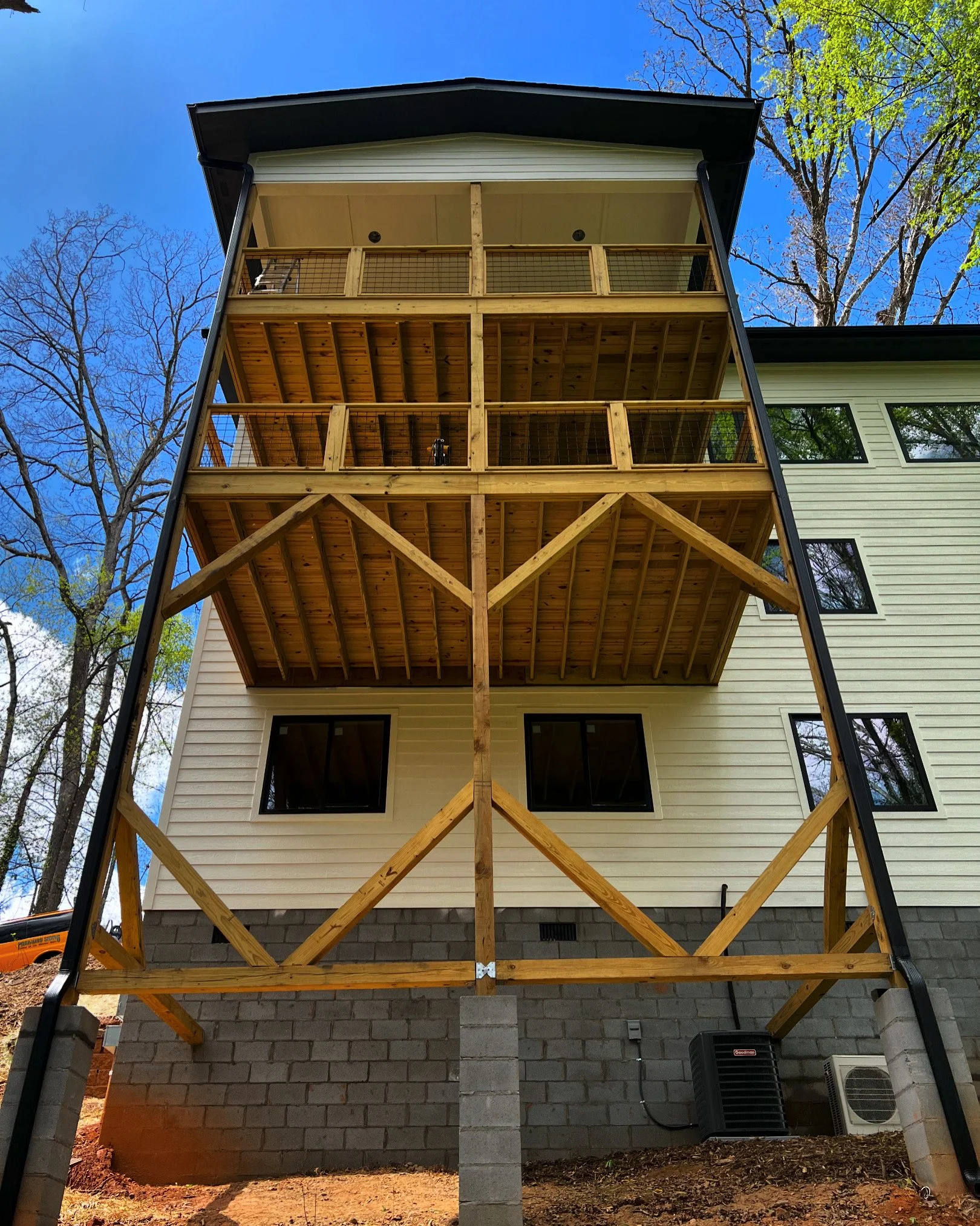 Completed gutter and downspout installation on a 3 story home with a slope in the back in the Kenilworth neighborhood of Asheville, NC
