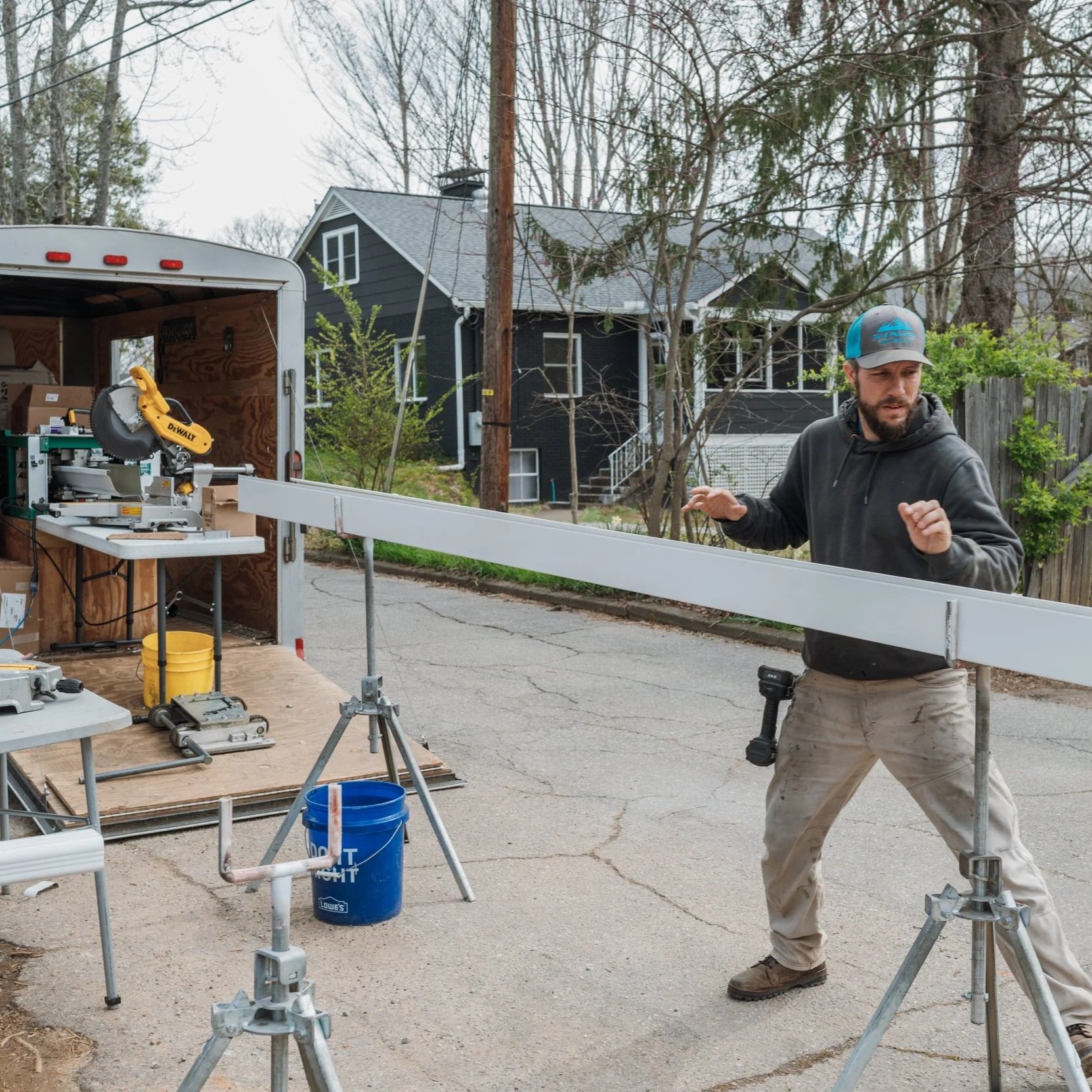 Gutter installers running the seamless gutter machine in the Oakley neighborhood of Asheville, NC