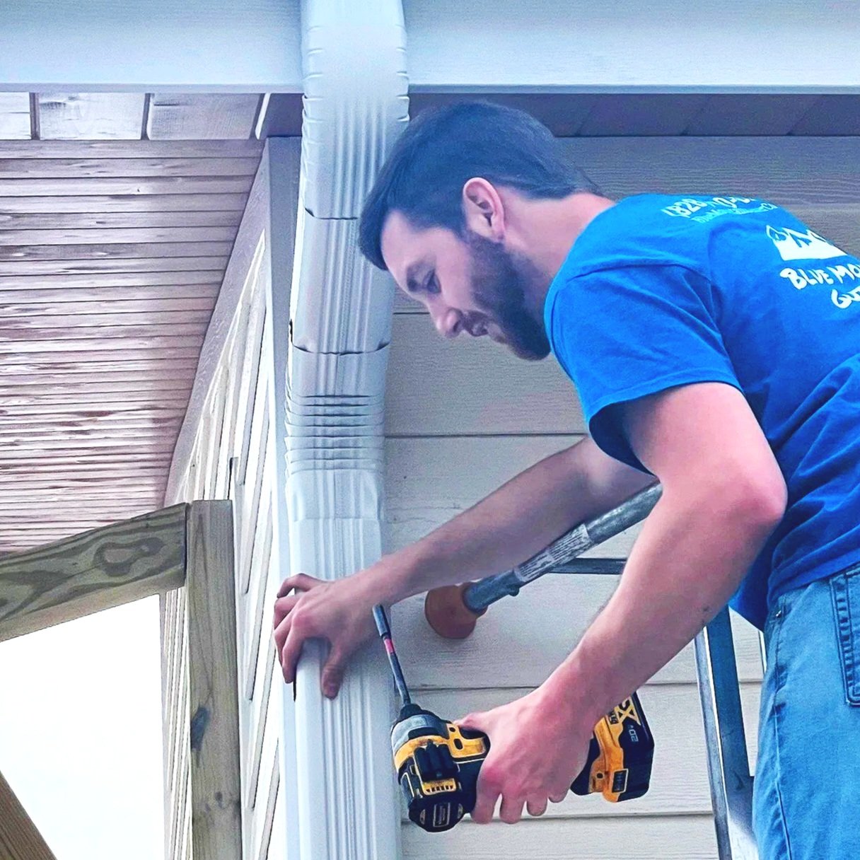 Crewmember installs a downspout in Asheville, NC