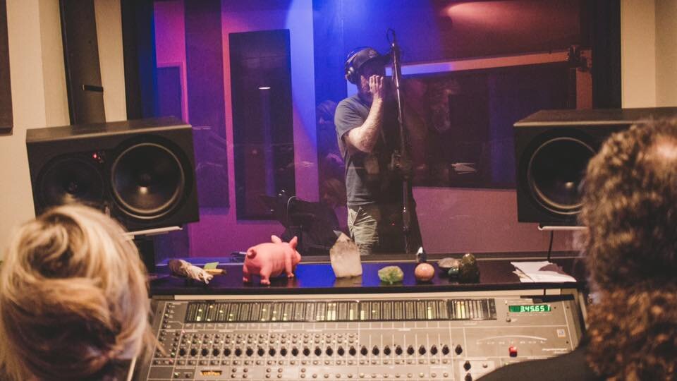 Kirk Norby, of Bear Market Riot, recording harmonica