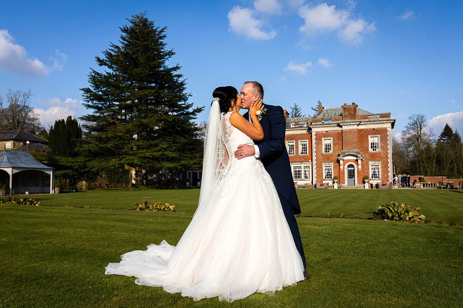 Michael Chilton Photography - Nicole and Chris celebrate with a kiss on the grounds at Eaves Hall, Clitheroe