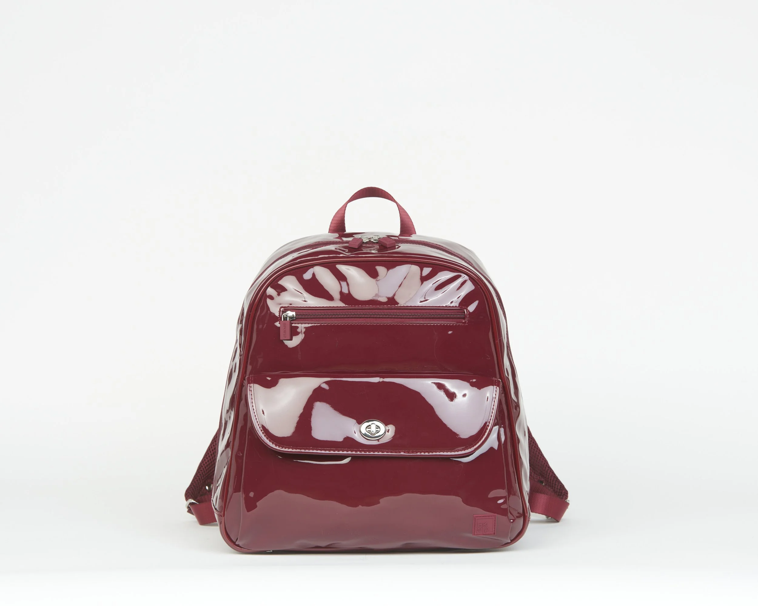 THE WITH-A-TWIST TURN LOCK BACKPACK - PATENT MERLOT