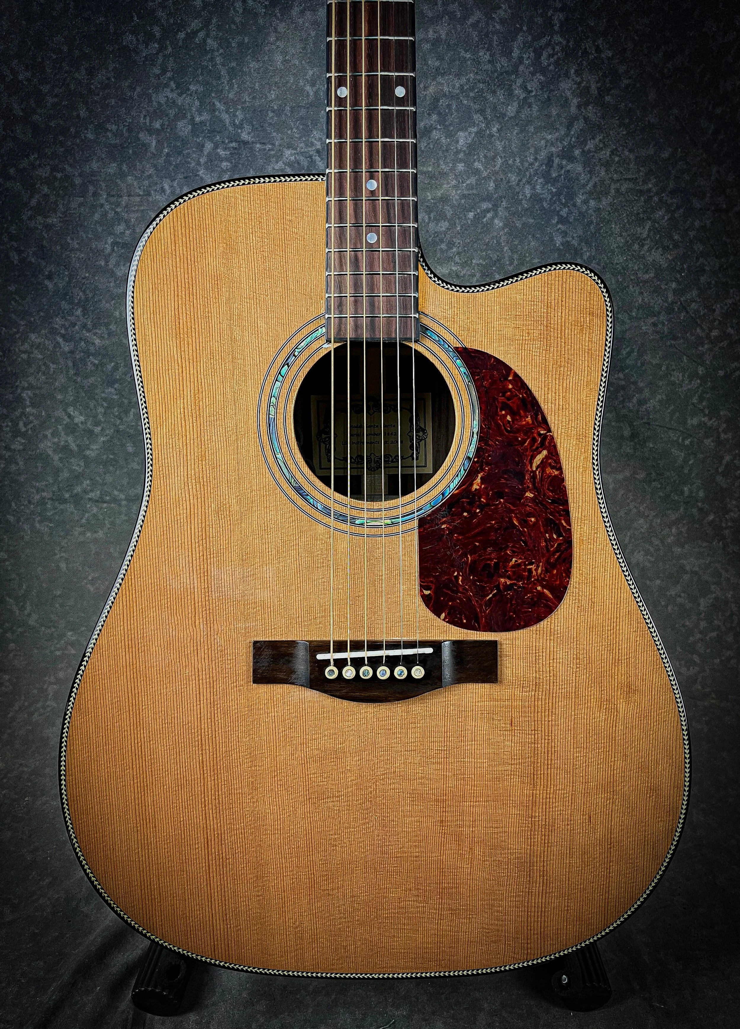 LSL Instruments Santa Clarita Dreadnought Cutaway Acoustic. Solid Rosewood back and sides, solid cedar top, herringbone binding, fishman electronics, Graphtech hardware. High quality import collaboration acoustic models.