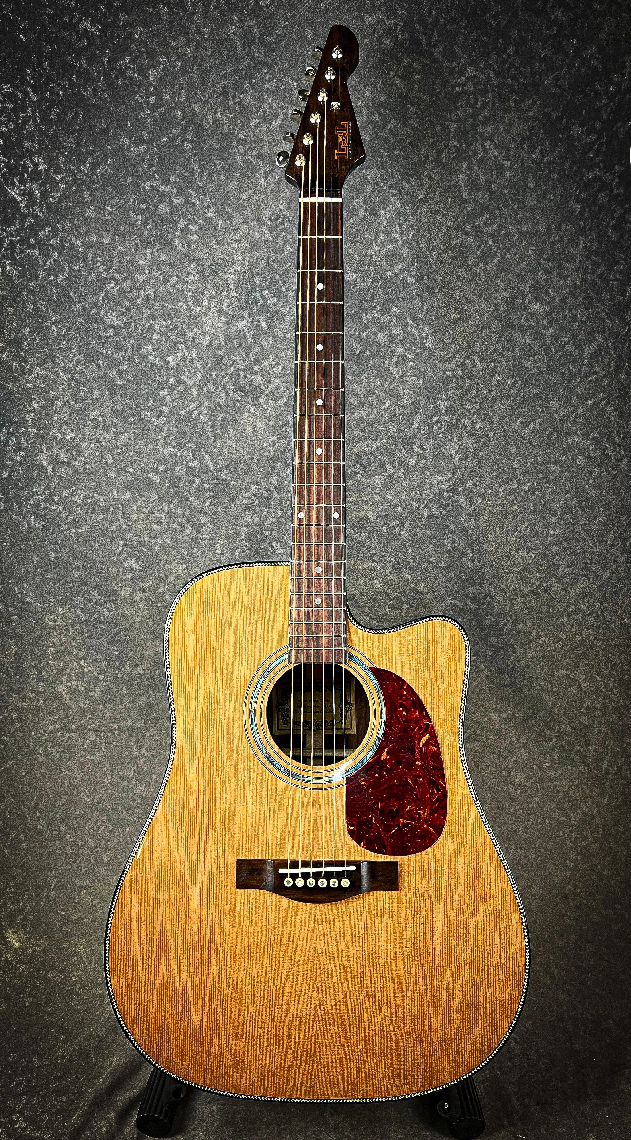 LSL Instruments Santa Clarita Dreadnought Cutaway Acoustic. Solid Rosewood back and sides, solid cedar top, herringbone binding, fishman electronics, Graphtech hardware. High quality import collaboration acoustic models.