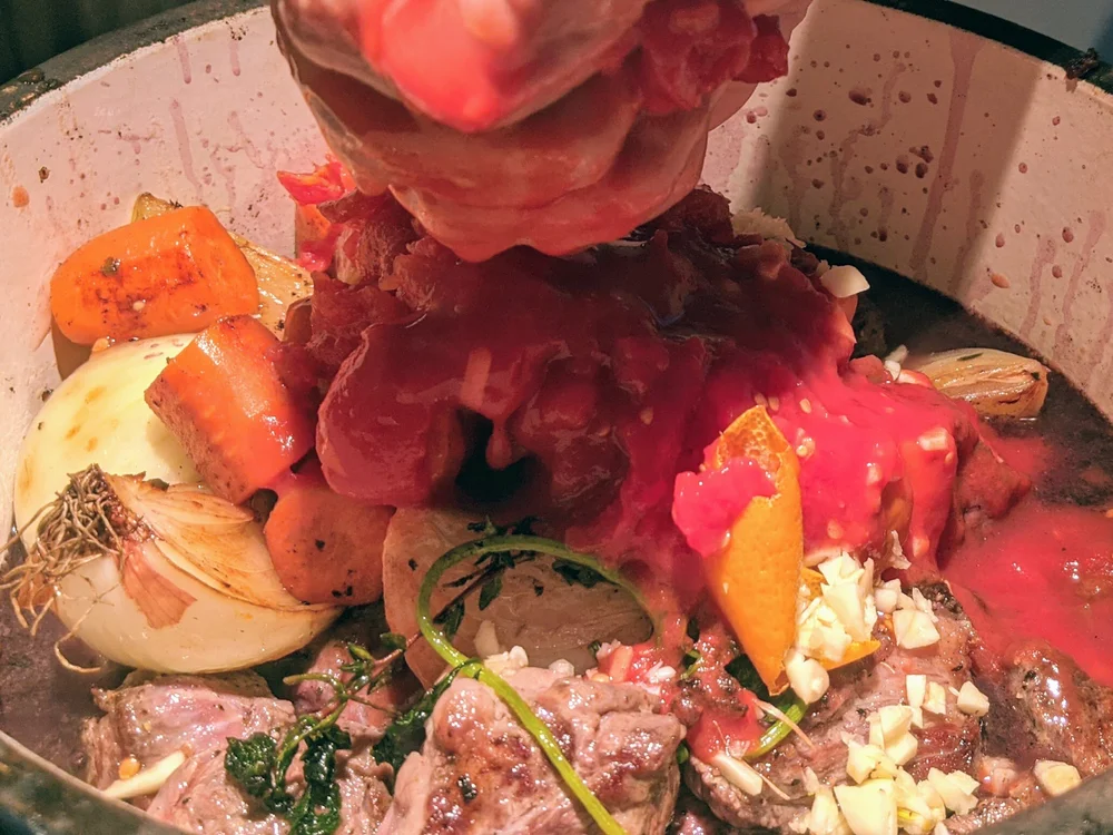 crushing tomatoes into stew.jpg