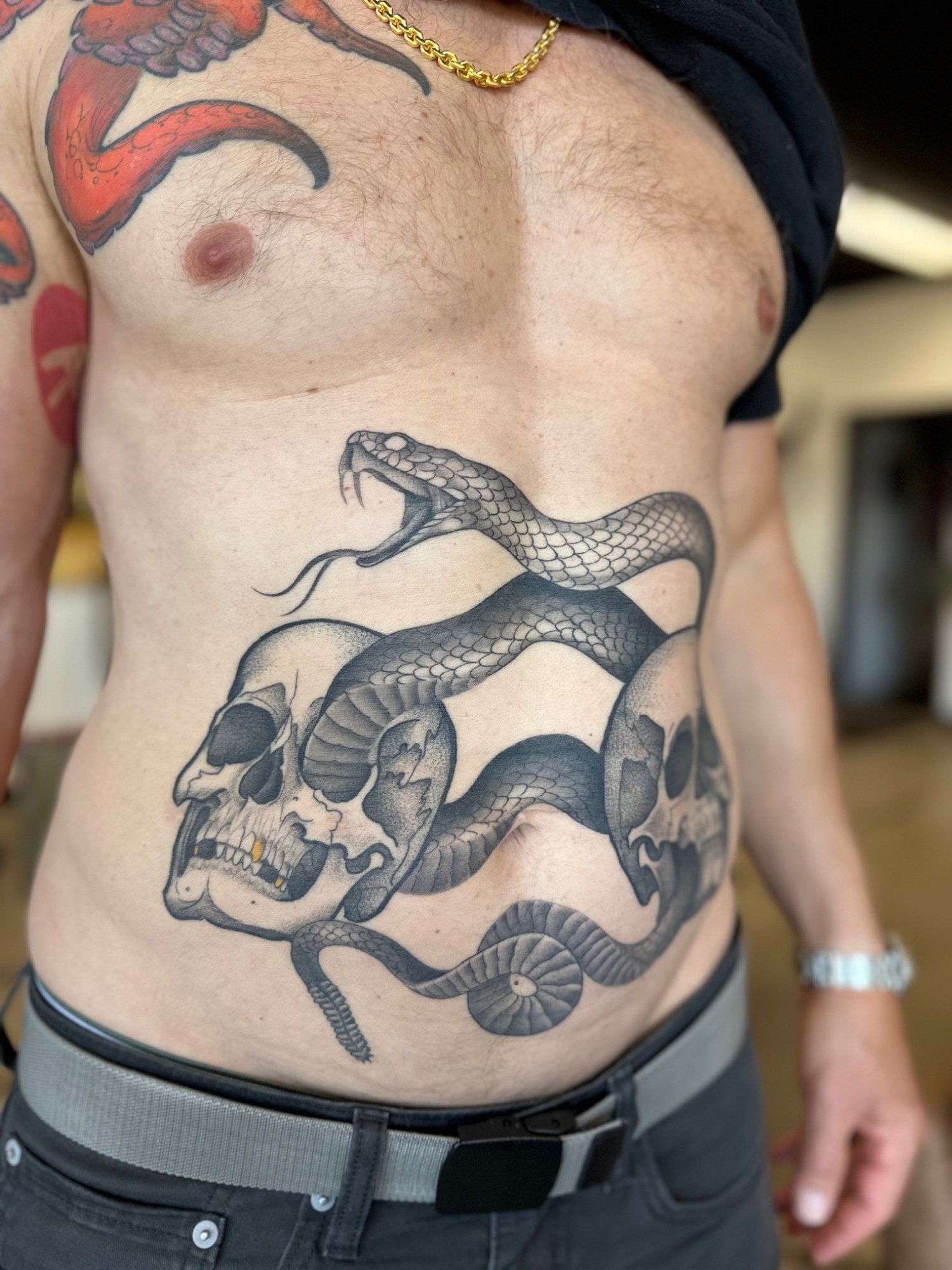 snake-and-skulls-stomach-tattoo-brian-foster.jpg