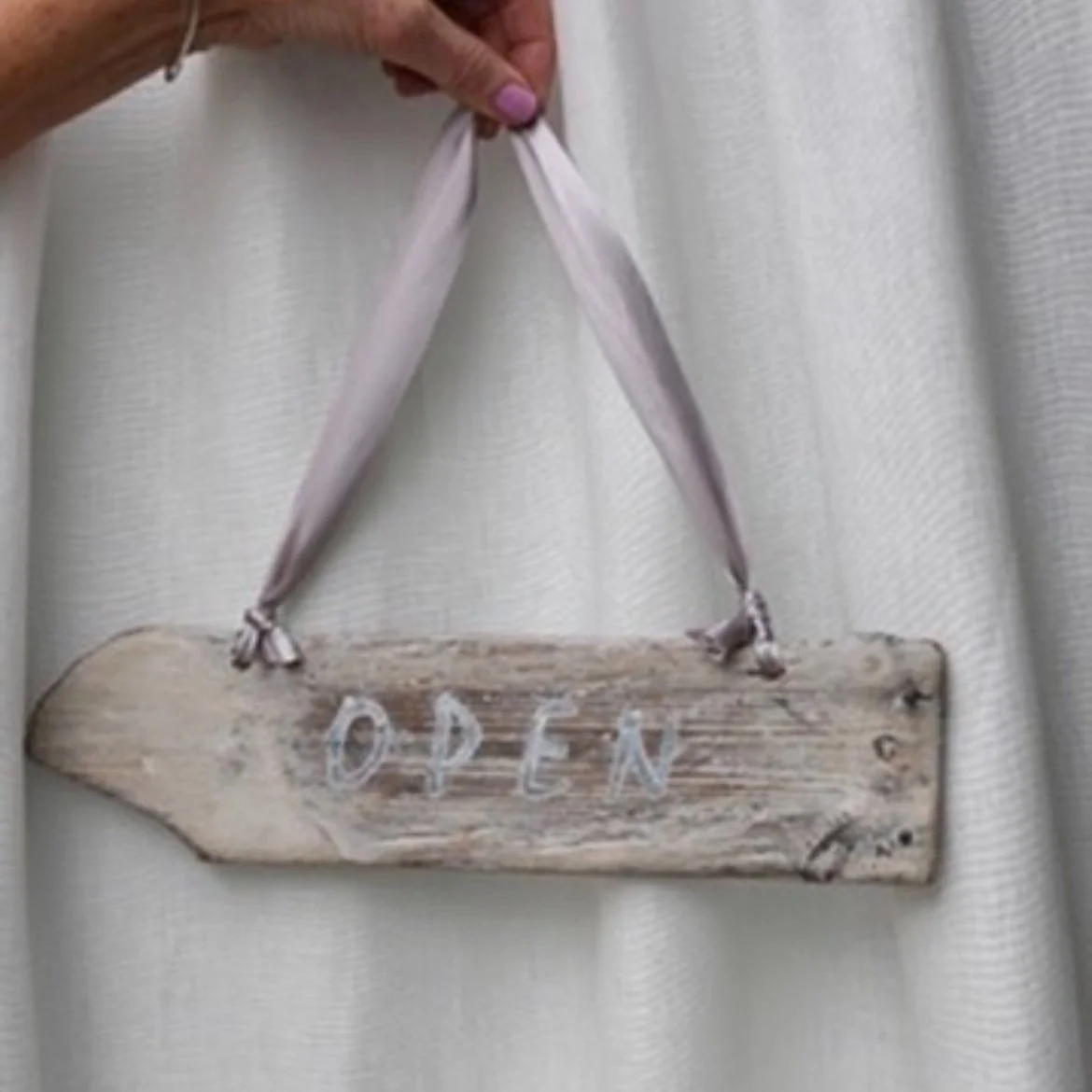 Rustic driftwood open sign at Bare Beauty studio in North Berwick, East Lothian