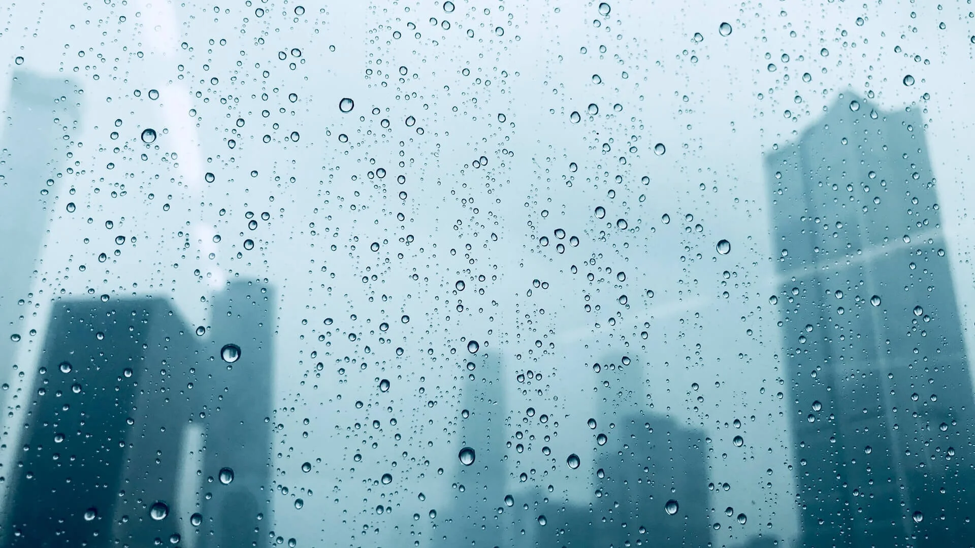 Rain on a window with city view by Xiaoyi Huang