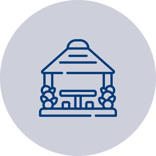 Line drawing of a small house or gazebo with a shingled roof, front porch, and two bushes on either side.