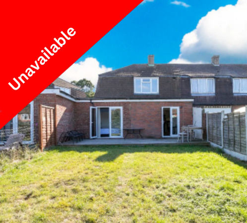 Backyard of a brick house with a lawn and patio area, under a partly cloudy sky, with an red banner that says 'Under Offer' in the top left corner.