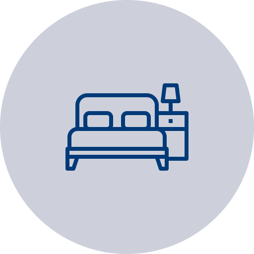 Icon of a bed with a nightstand and a lamp