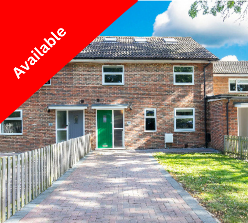 Brick house with a green front door, small windows, a paved driveway, a wooden fence on the left, and a lawn on the right, under a blue sky with clouds, with an 'Under Offer' banner in red and white.