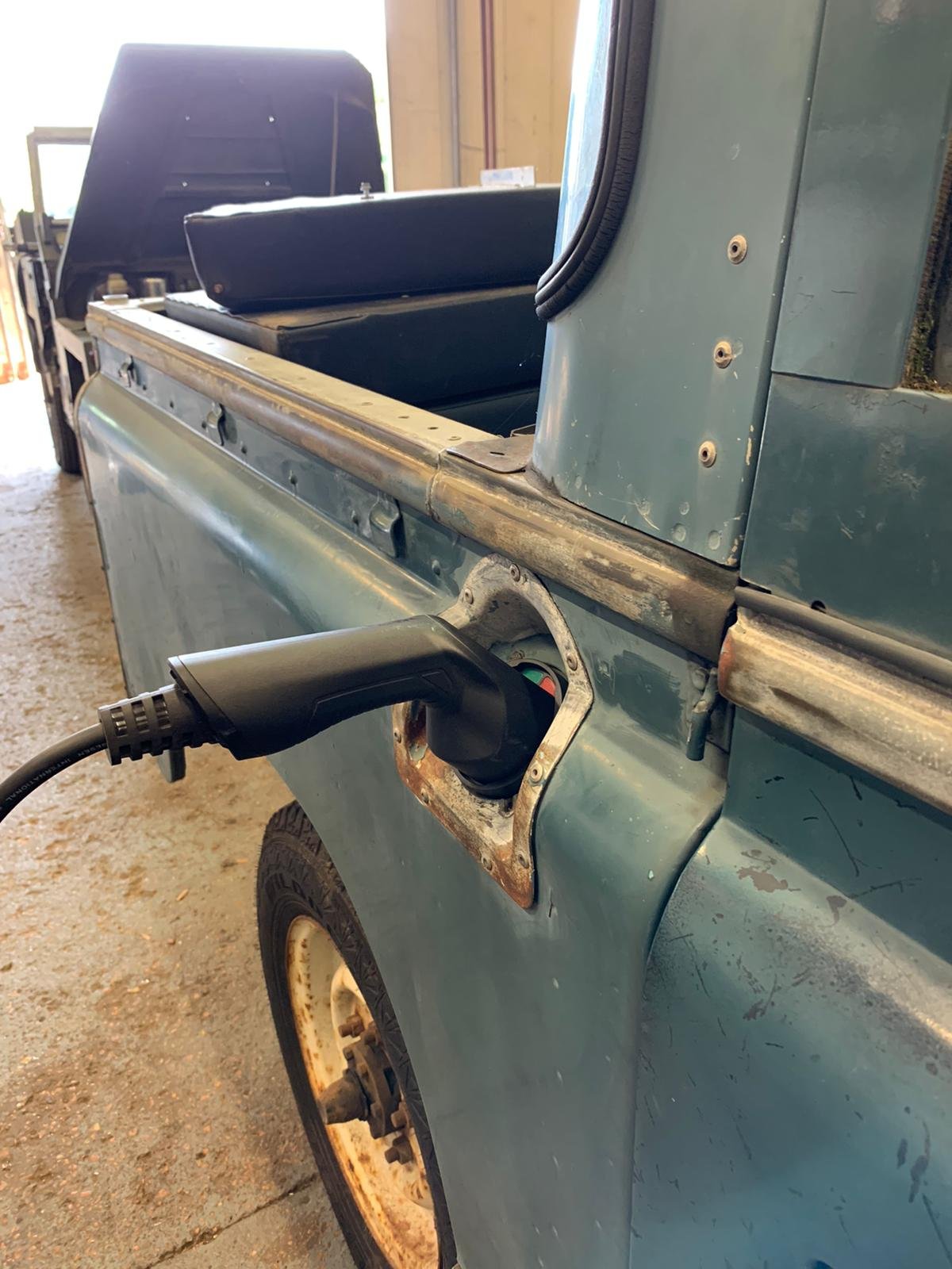 Electric Series 2 Land Rover being charged up with a type 2 charge port