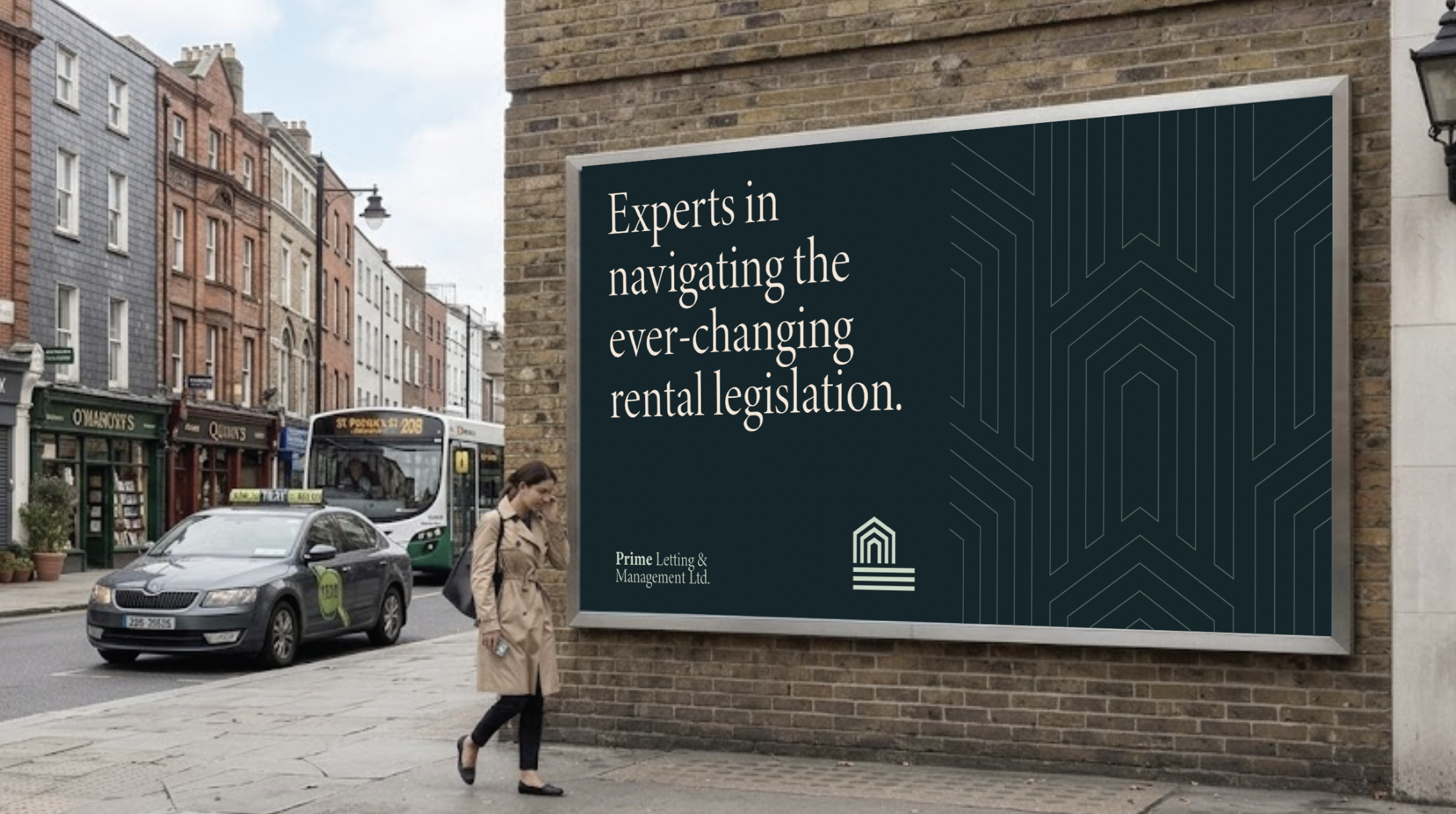 Street scene with a woman walking past a large advertisement on a brick wall. The ad reads, 'Experts in navigating the ever-changing rental legislation,' and is from Prime Letting & Management Ltd. There are shops, a bus, and cars on the street.