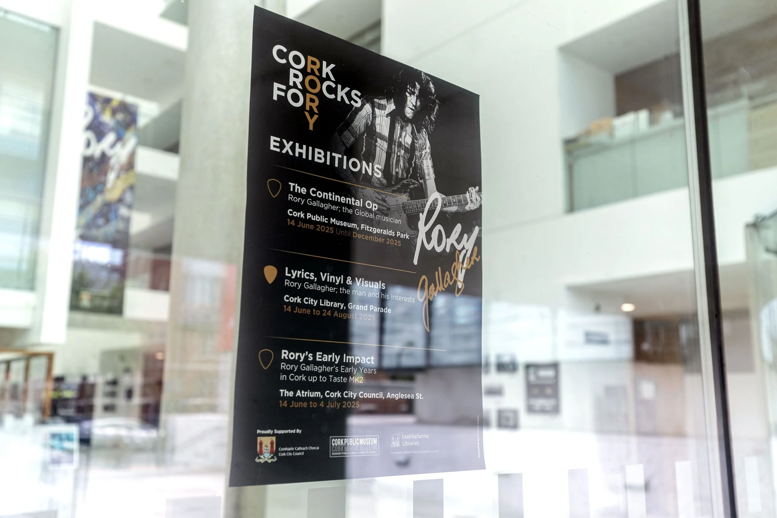 Poster for Cork Rocks Rory Gallagher exhibitions at Cork Public Museum and Cork City Library, featuring Rory Gallagher playing guitar.