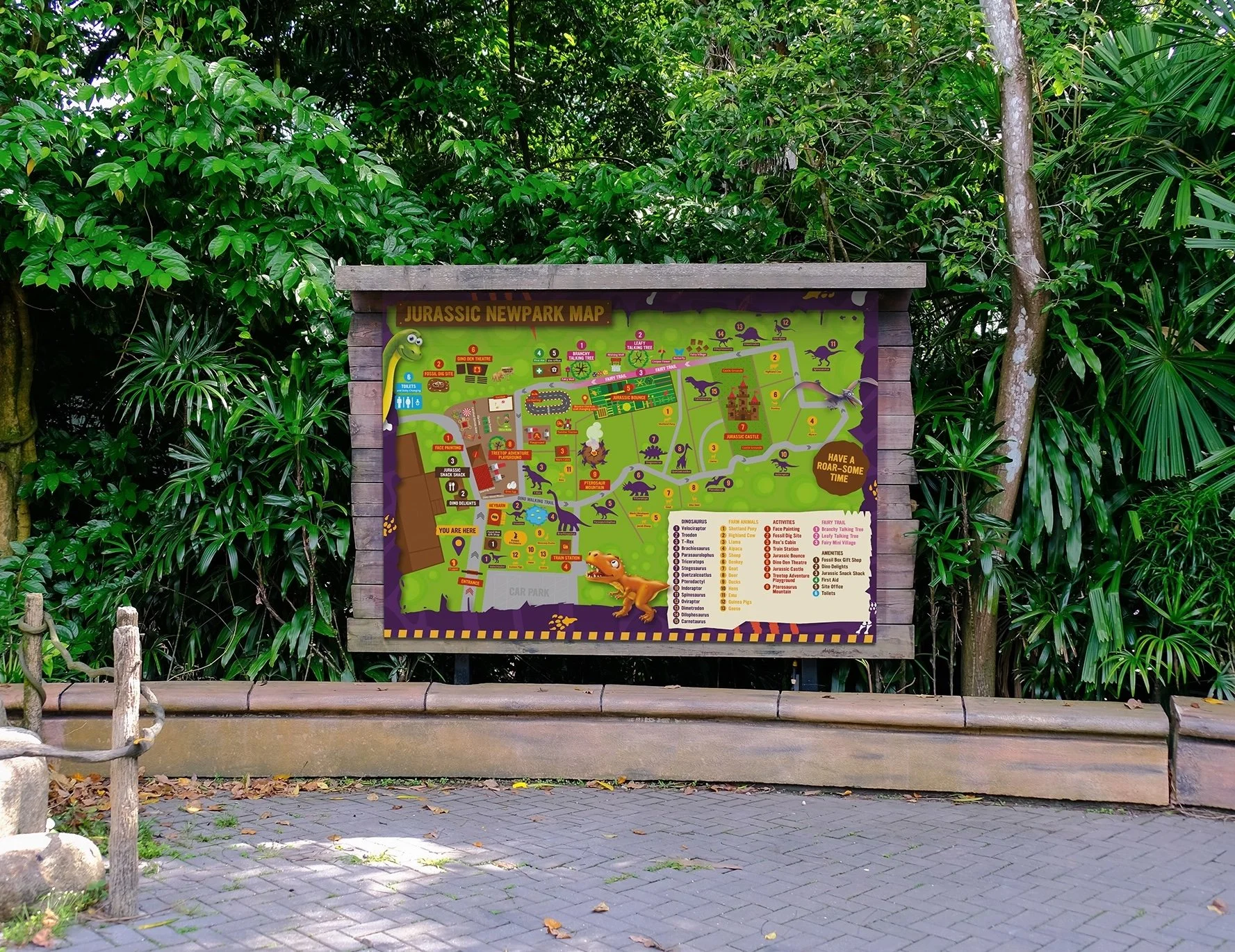 Jurassic Newpark map signboard surrounded by lush green plants and trees.