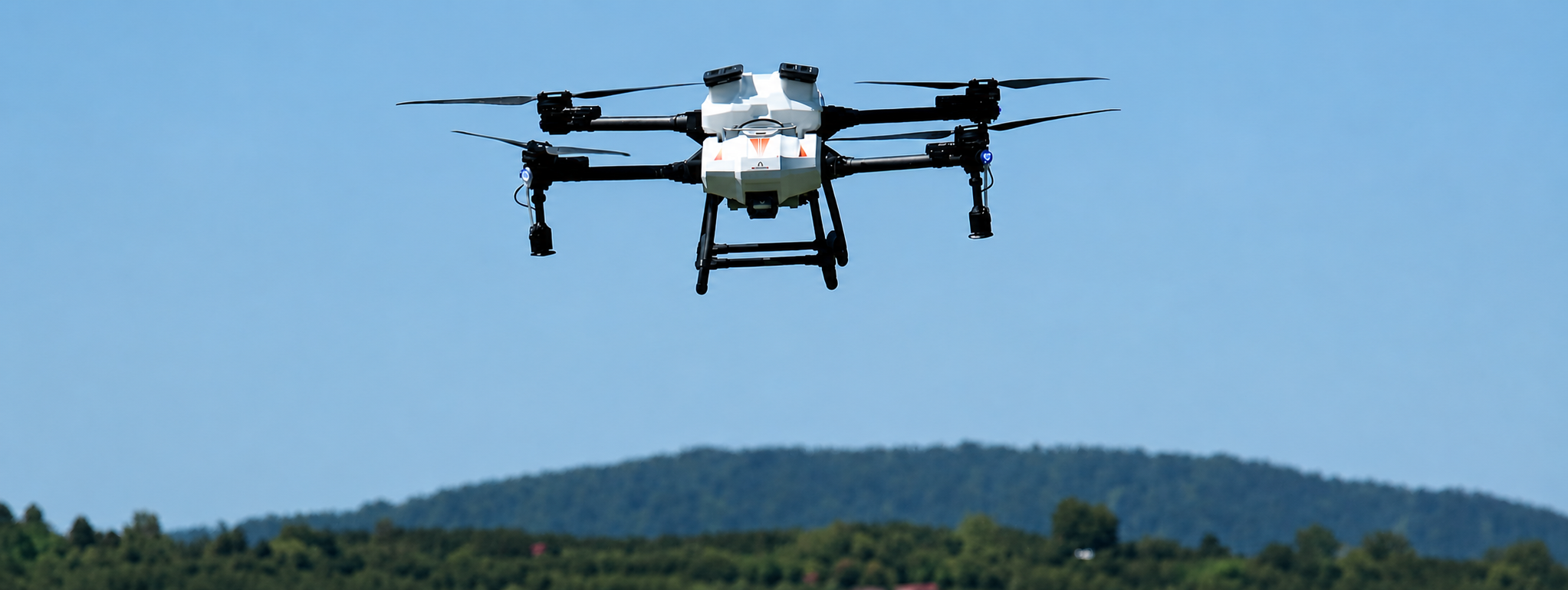 ABZ Innovations agricultural drone in flight for precision spraying and crop management operations.
