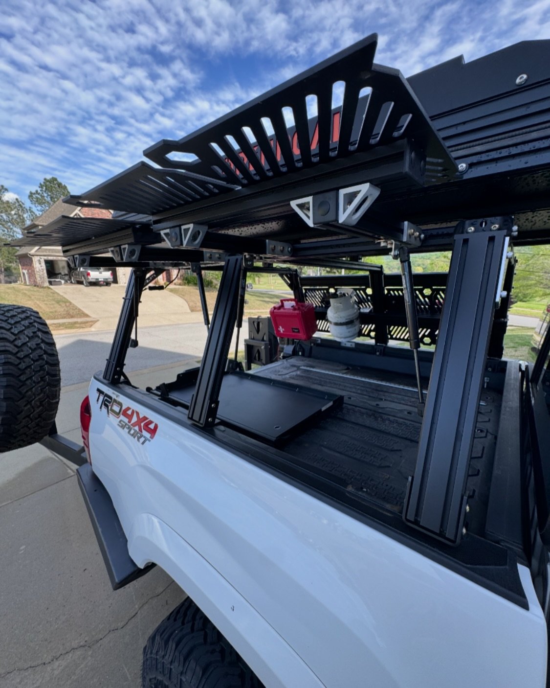 The Xtrusion racks we install on trucks have the option for access gates. These things are super tough and can hold a bunch of weight. Let us know if you want help installing!