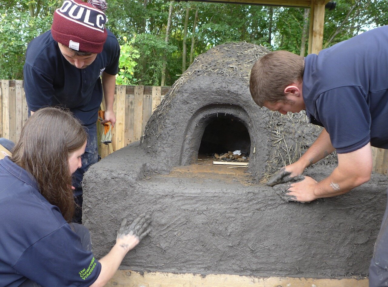Shaping the clay oven with TCV wild skills trainees