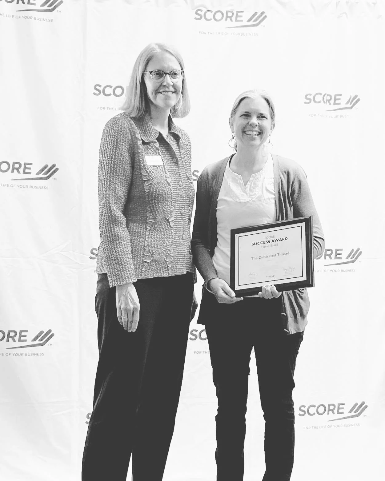 Hilary Crowell and business mentor, Linda Diou, pose to receive the home based business award